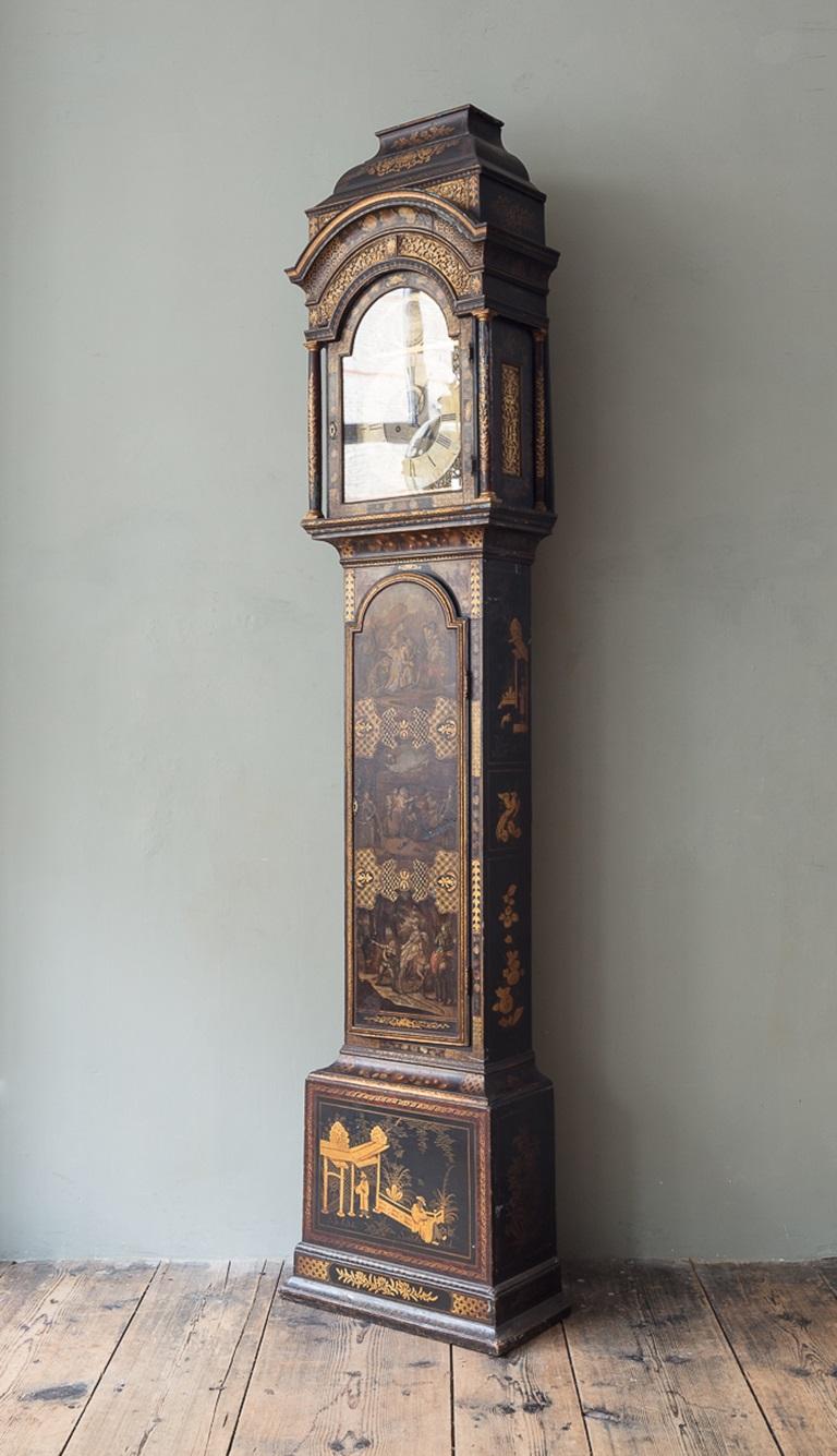 An 18th Century Longcase Clock

The case with broken-arch top and stepped caddy, cresting above foliate frets and simulated tortoiseshell hood pillars, the broken arch trunk door decorated with three prints of scenes from Don Quixote (three original