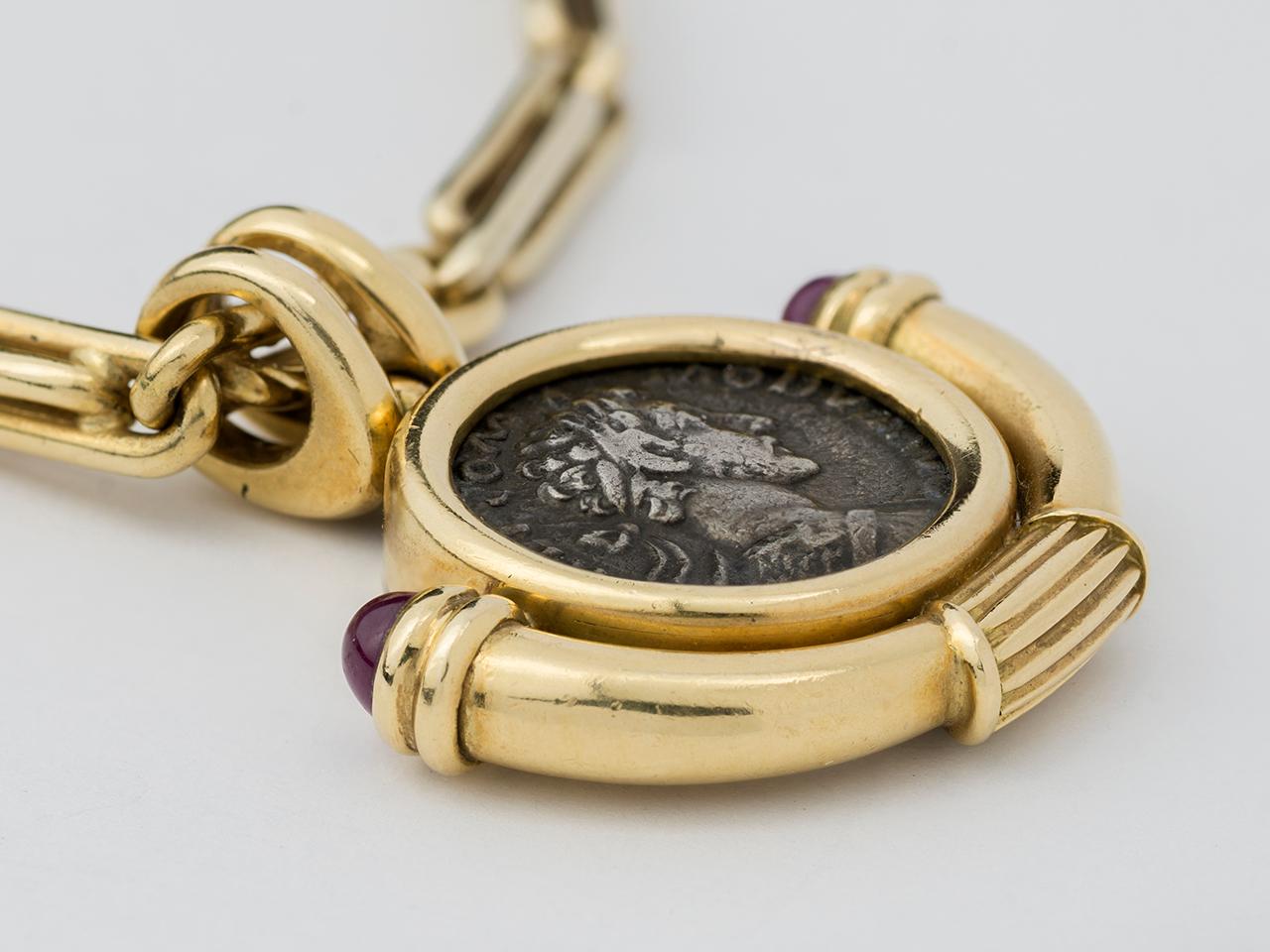 18kt gold longchain necklace, suspending an ancient coin set in a fob bezel. Necklace is 35-1/2” in length, and can be doubled. Signed BVLGARII 750. Both signed.