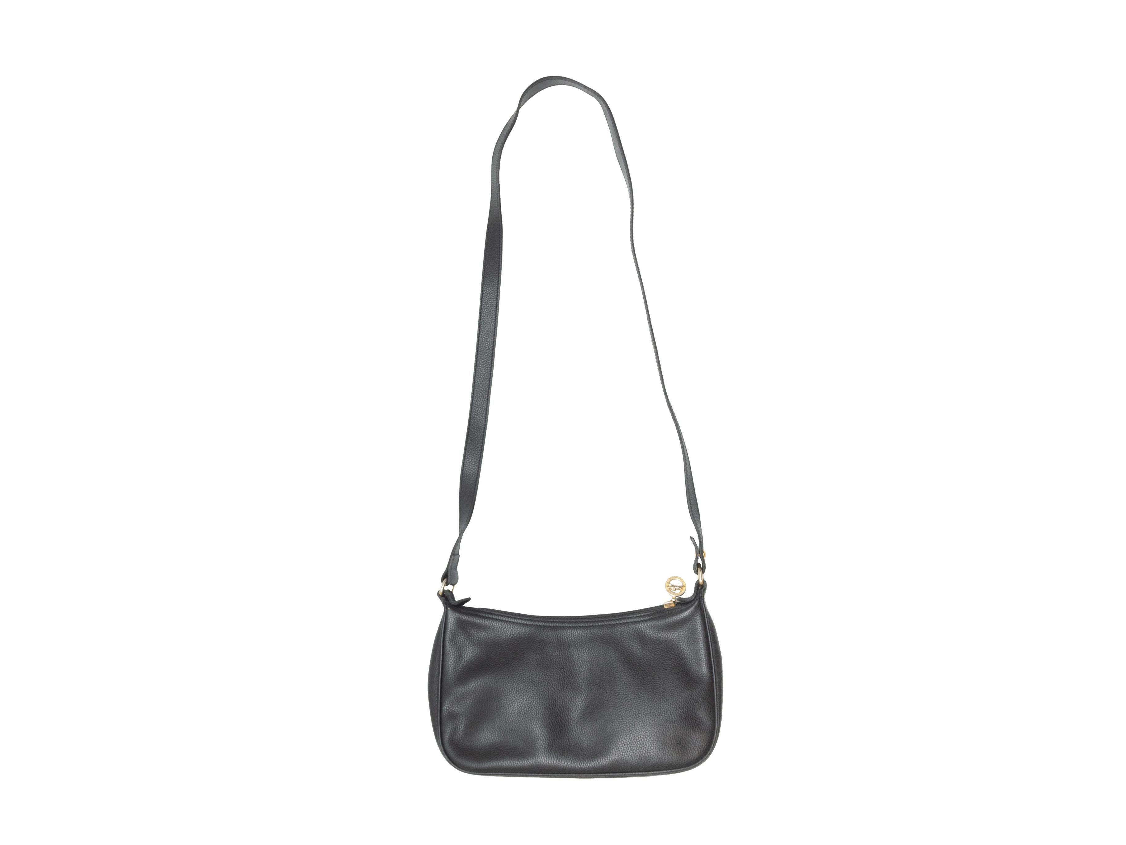 Product details: Vintage black leather mini crossbody bag by Longchamp. Gold-tone hardware. Zip closure at top. 10.5