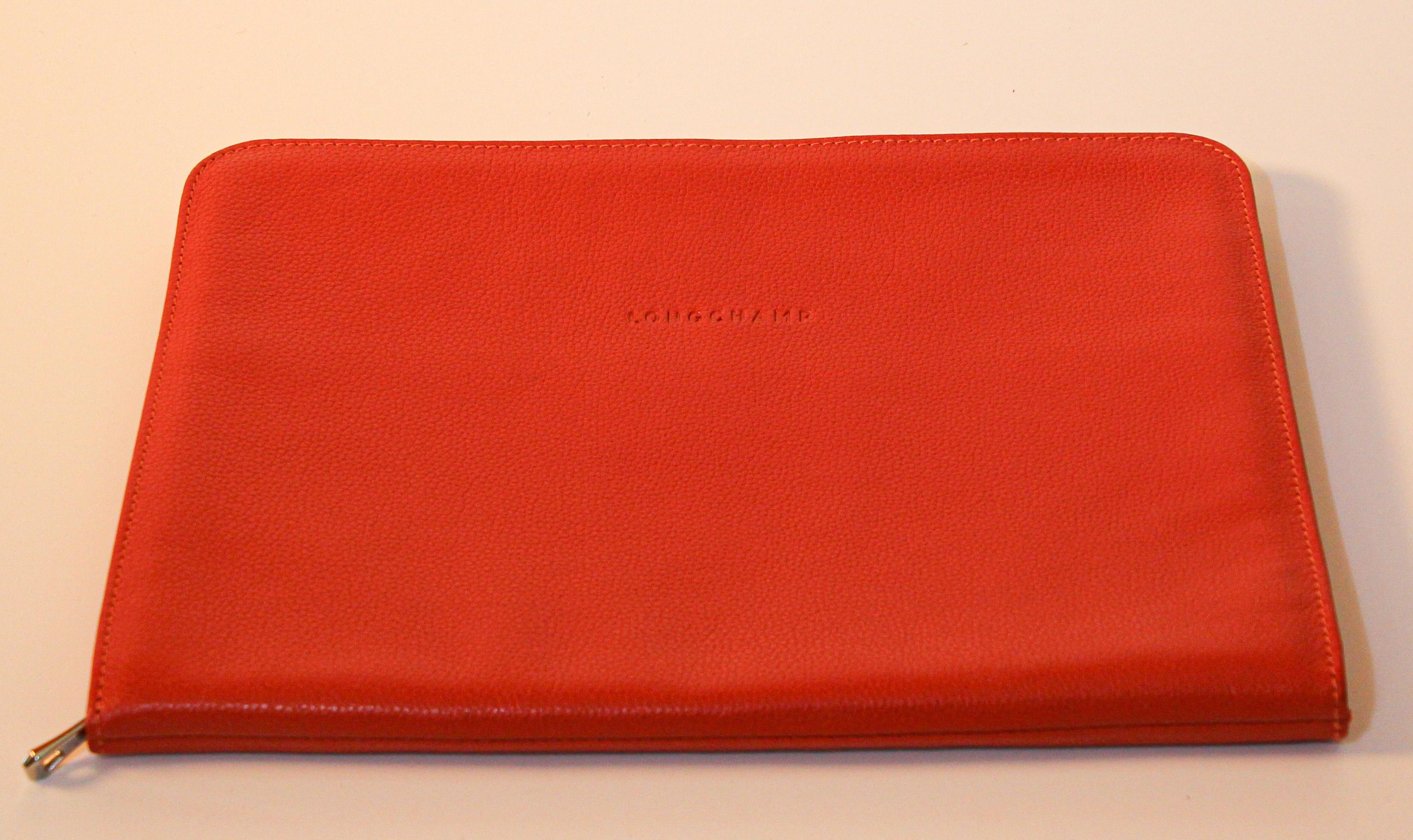 Longchamp leather burnt orange hand tooled leather computer case.
This elegant zipped case will both embellish and protect a 13-inch computer. 
