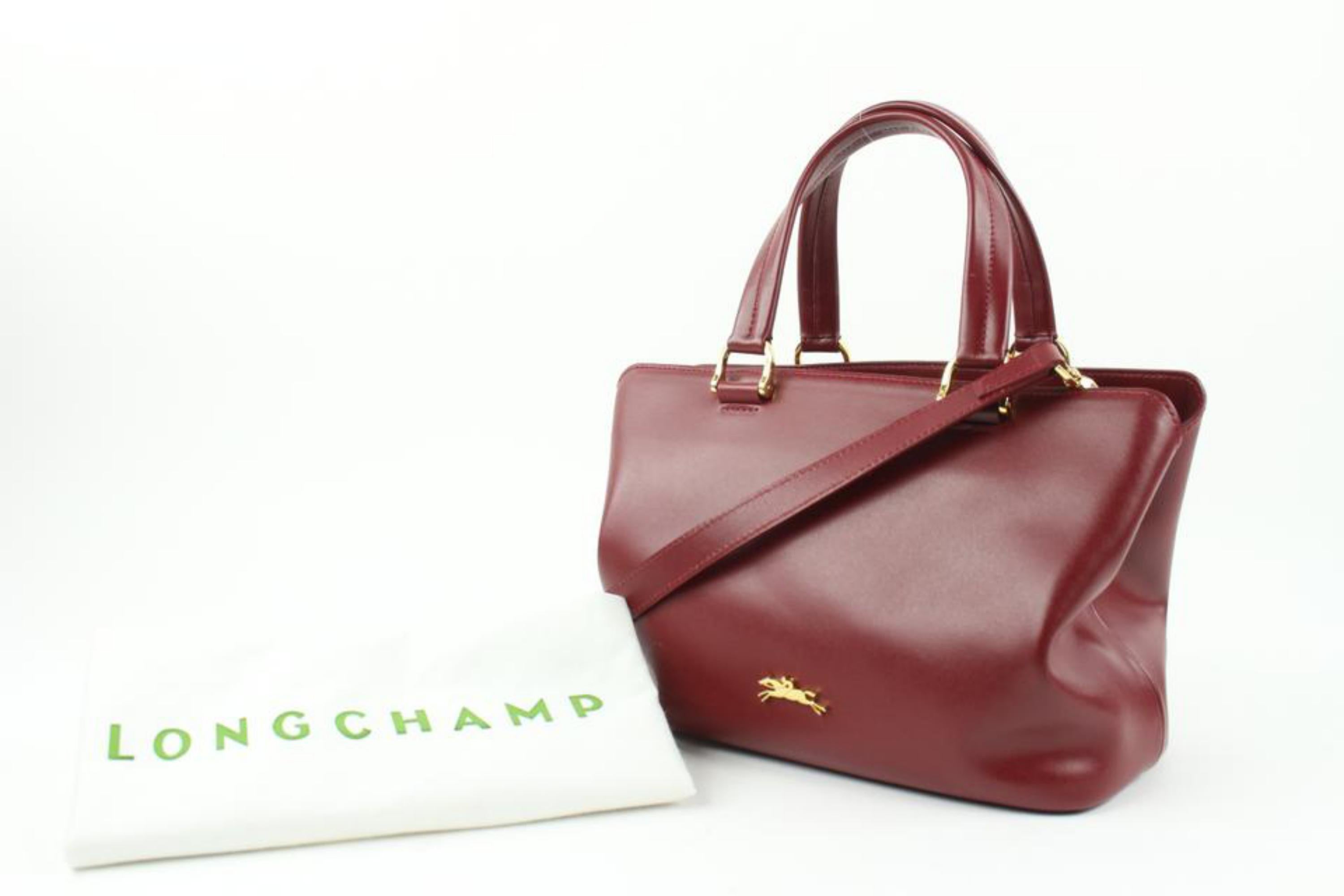 Longchamp Dark Red Burgundy Leather 2way Tote Bag with Strap 10LC113
Date Code/Serial Number: 1008445 1099831609
Made In: France
Measurements: Length: 11.5 