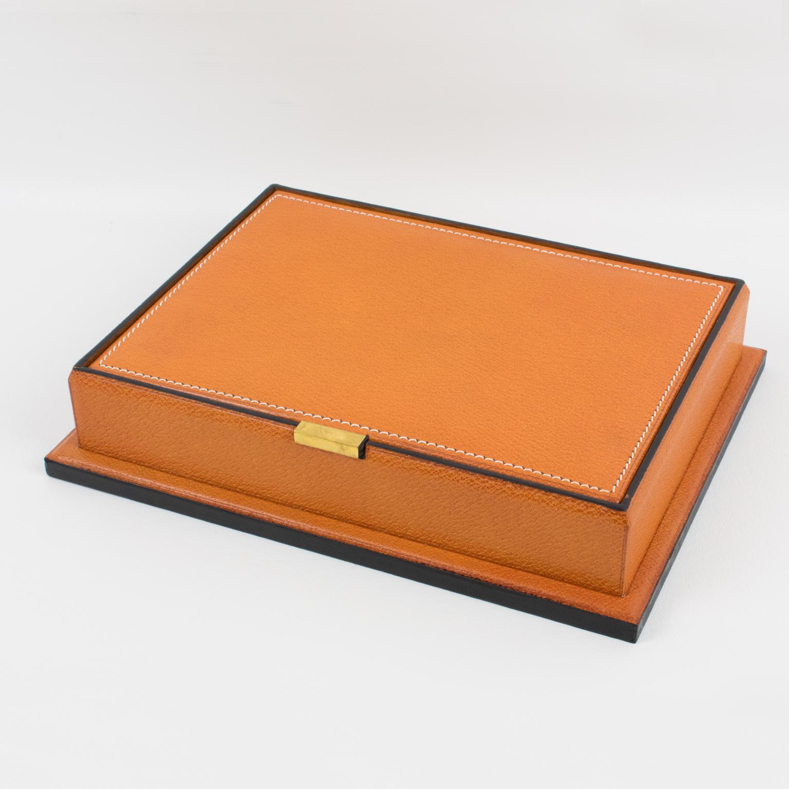 Beautiful 1940s modernist leather decorative box, desk accessory by Longchamp, Paris. Natural light cognac leather with pattern and hand-stitched finish. Tiny brass handle and varnish wood interior with compartments. In pristine condition, still