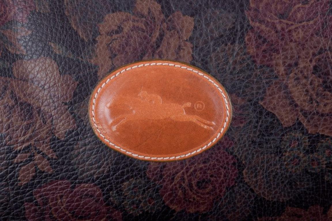 Late 20th Century Longchamp, France. Travel bag in full-grain leather with a rose motif. For Sale