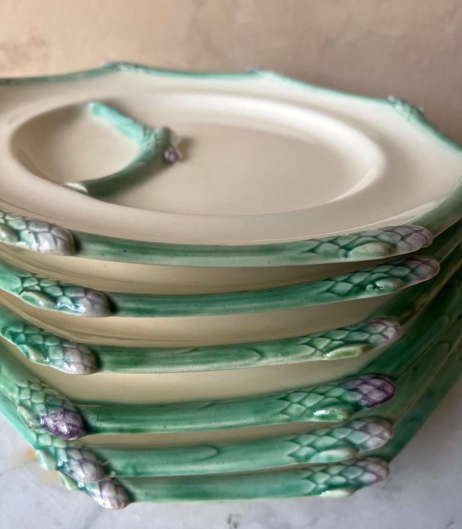 Set of six Terre de Fer Asparagus Plates made by Longchamp in France around the 1920's. The asparagus stalks in relief form surround the octagonal edge as well as on the plate to create a sauce well or separation area.
Each plate is impressed