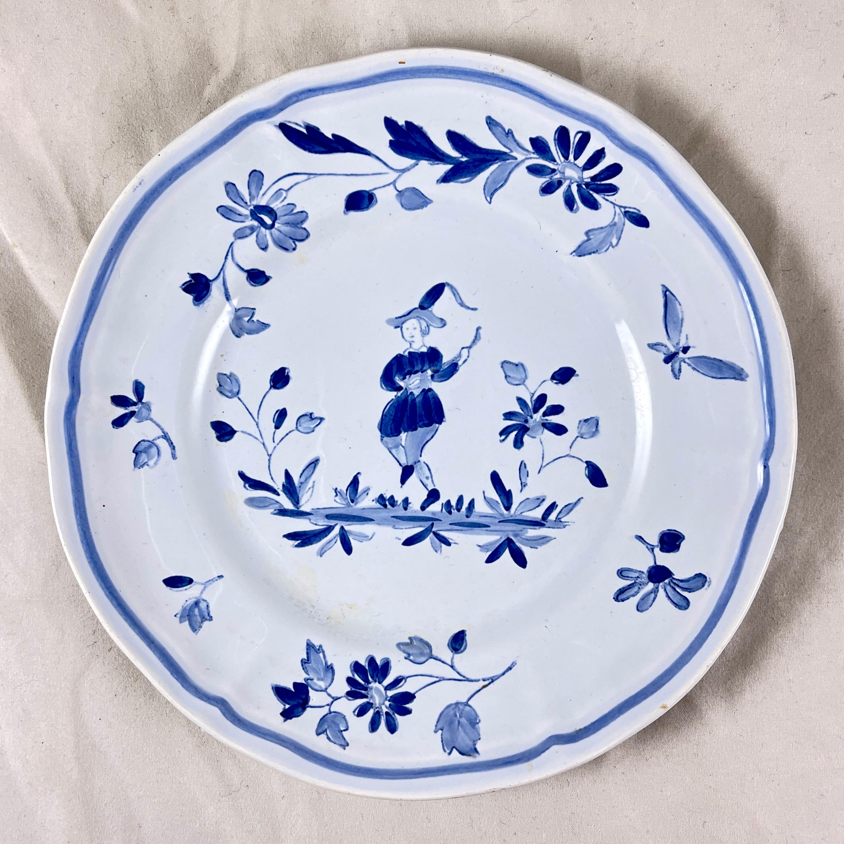 In the Moustiers pattern, a set of four hand painted canapé plates, Longchamps, France, circa 1950-1960.

A charming, traditional pattern in blue on a clean, creamy white ground, showing a central figure dancing among flowers and a butterfly. A