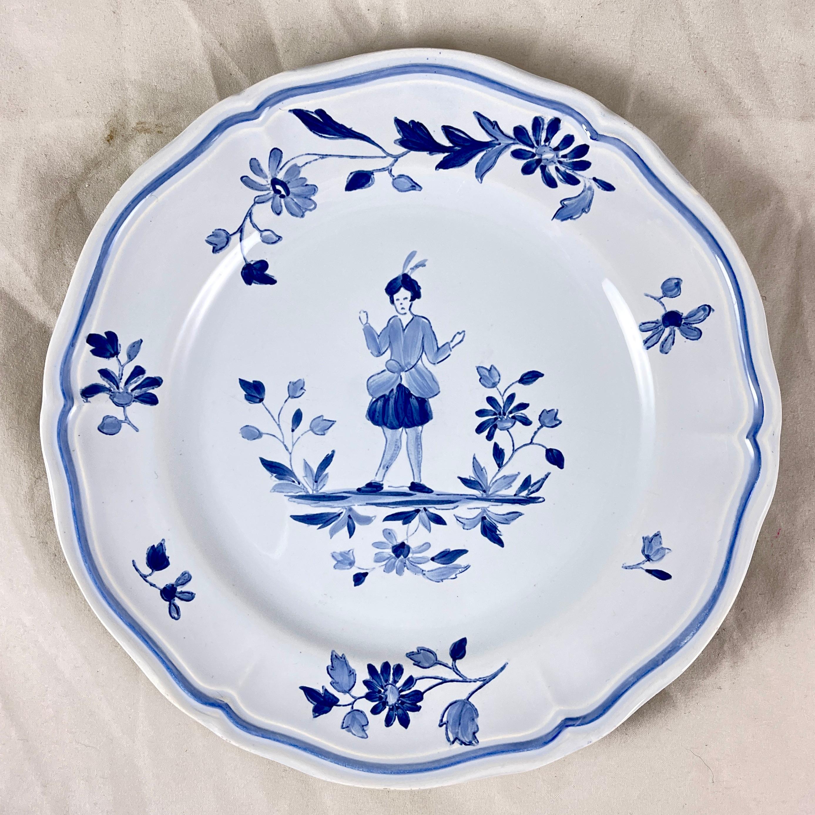In the Moustiers pattern, a set of four hand painted dessert plates, Longchamps, France, circa 1950-1960.

A charming, traditional pattern in blue on a clean, creamy white ground, showing a central figure standing among floral bouquets and sprays.