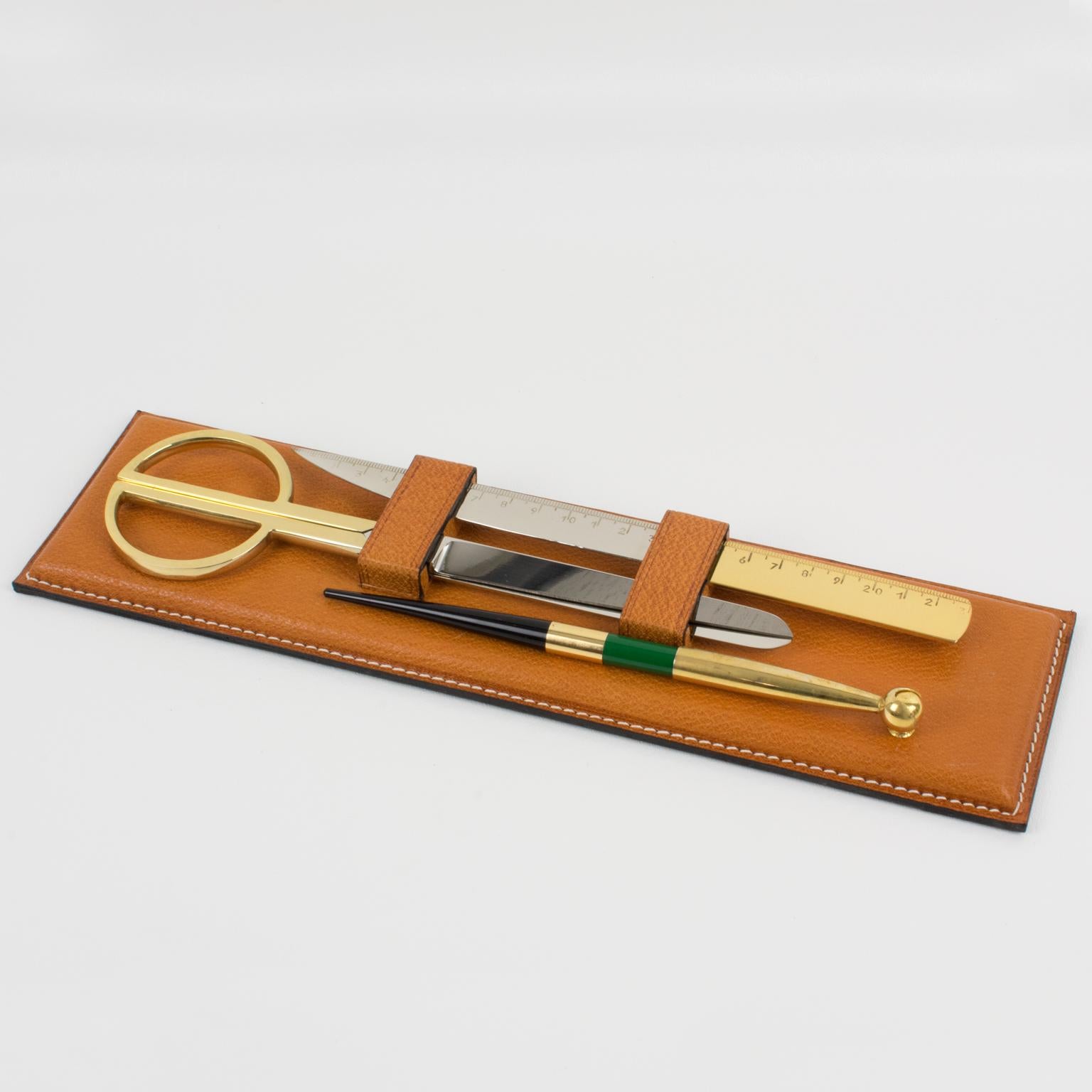 Stylish 1940s modernist leather desk accessory set by Longchamp, Paris. Natural light cognac leather with pattern and hand-stitched finish base with a pen, a letter opener, and a pair of scissors. The pair of scissors is in polished brass and chrome
