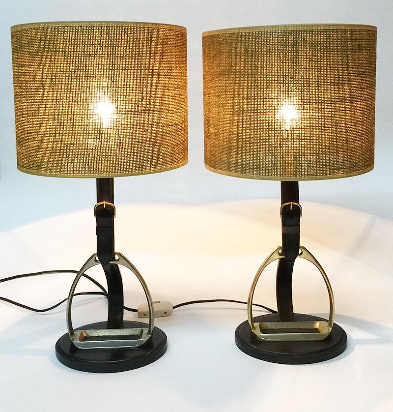 Longchamp stirrup stitched leather lamps, France 1950s

Longchamp Paris table or desk lamps in black and dark brown stitched leather with stirrup in brass, 1950s
Signed with Longchamp Paris on bottom in gold print
New shades 
The measurements