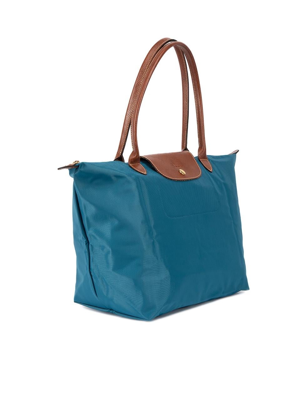 CONDITION is Never Worn. No visible wear to bag is evident on this used Longchamp designer resale item. Details Peacock blue Nylon Large tote bag Collapsible with snap button closure Brown leather trims 2x Rolled top handle Top snap button and top