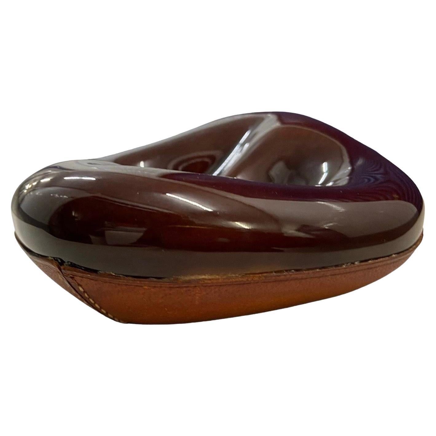 1950's Longchamp leather and ceramic pipe holder, ashtray, dish, signed / stamped in the leather, Lonchamp Paris.
French, circa 1955.
Beautiful organic shape.
This design is often attributed to Georges Jouve. 
Please note that our handling time is