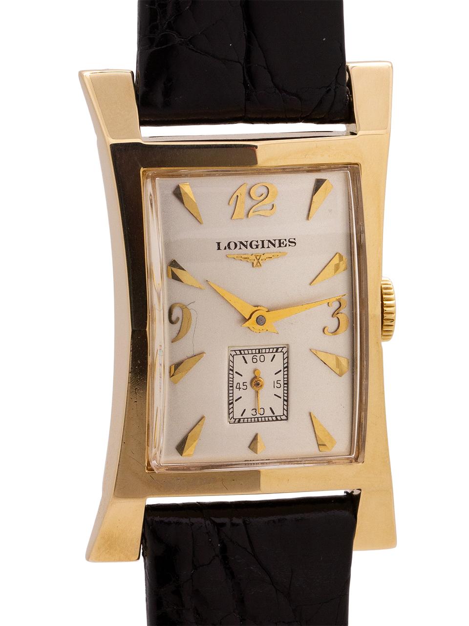 
Longines 14K YG  elongated hour glass shaped case measuring 21mm at its narrowest, 27mm at its widest and 41mm lug to lug. Scarce vintage model in exceptional condition. With beautifully restored silver satin dial with gold raised indexes and gold