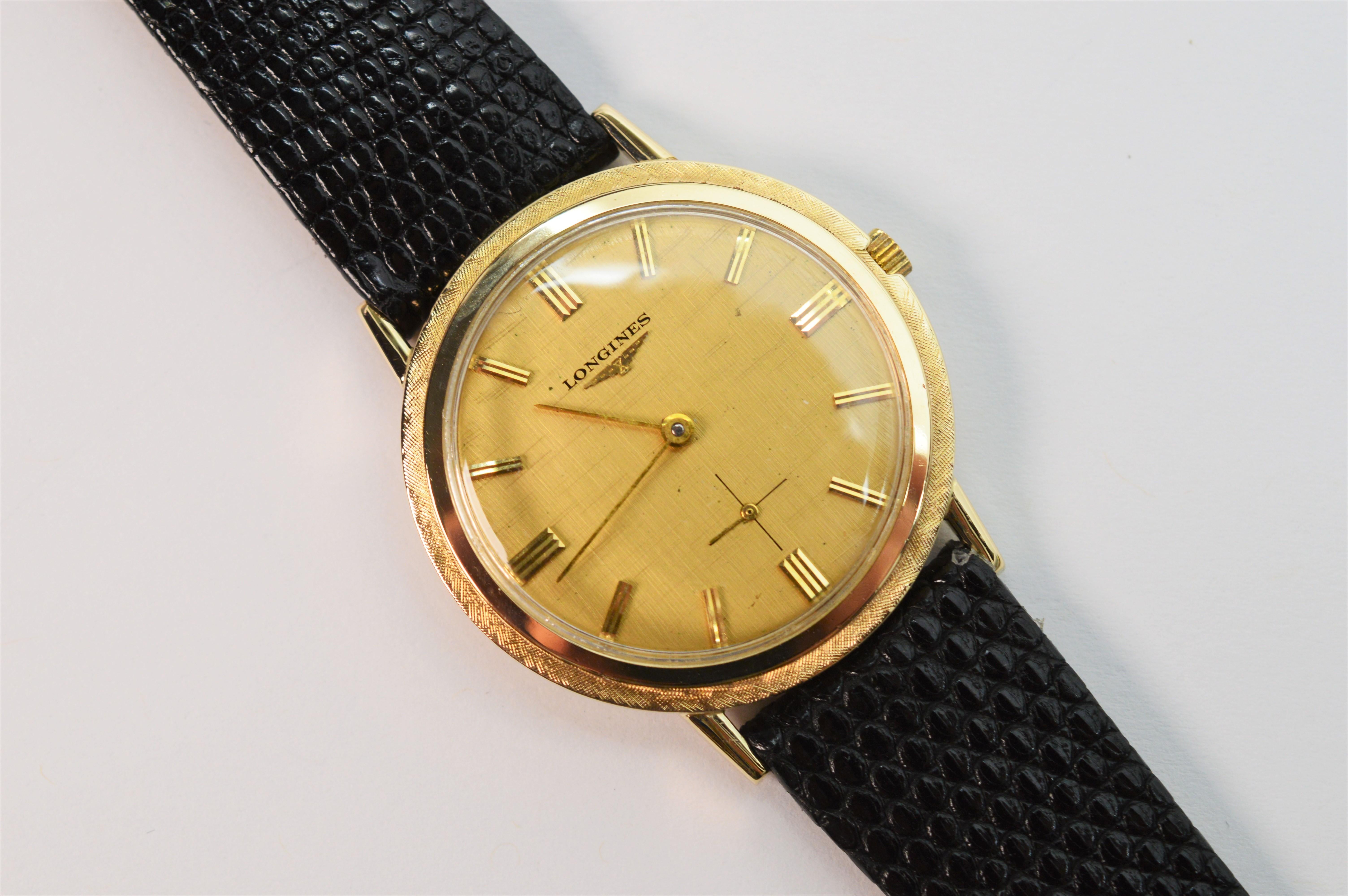 The slim lines of this 14K Yellow Gold Men's Longines Wrist Watch deliver retro style and comfort. Light weight, measuring 33mm with a manual wind 17 jeweled movement #12309475 LXW. 
The face of this vintage Longines is gold tone with matchstick