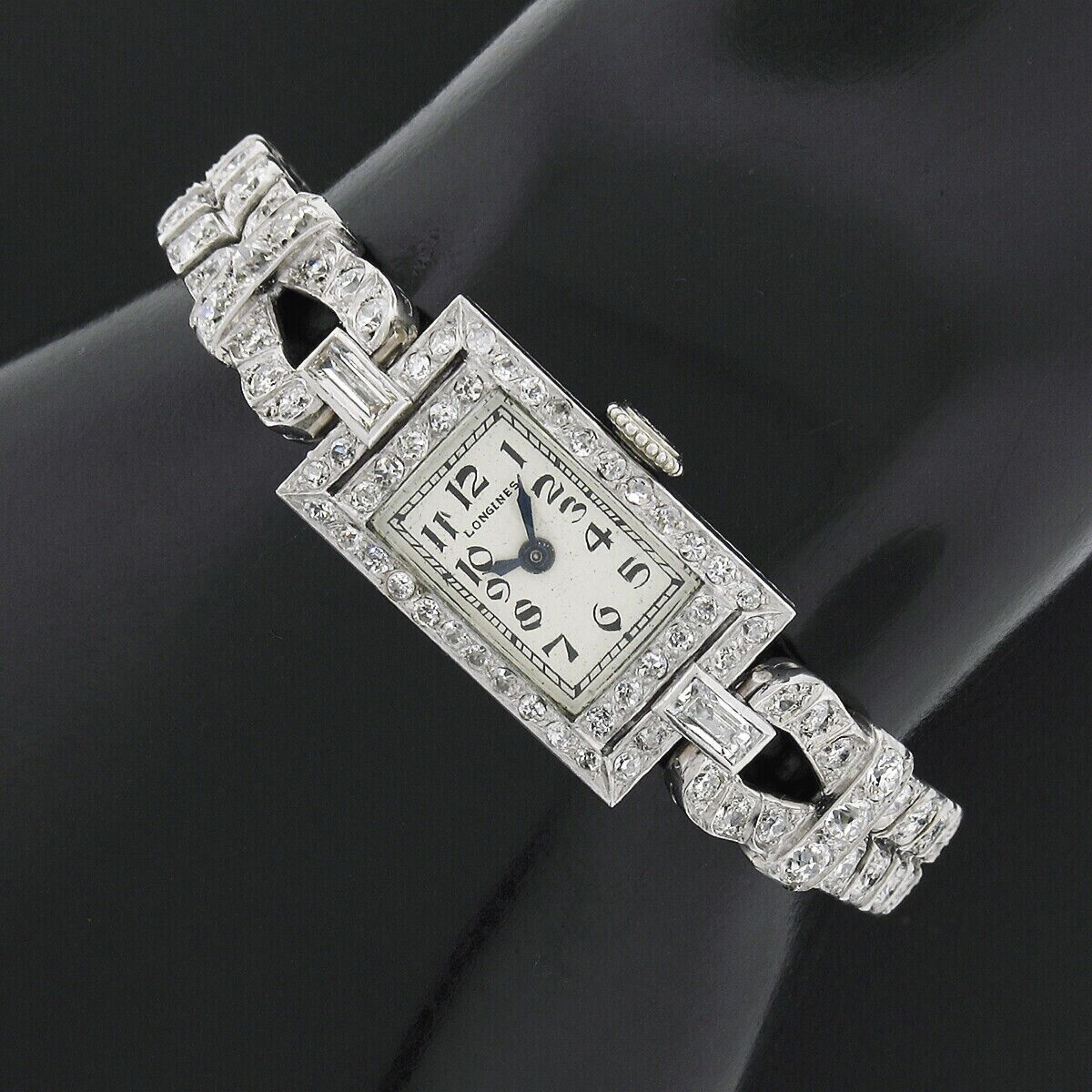 Here we have a very fancy antique Longines ladies' watch that was mounted in an elegantly designed case and bracelet. Both were crafted from solid 18k white gold and are completely covered with approximately 5.05 carats of fine quality diamonds.