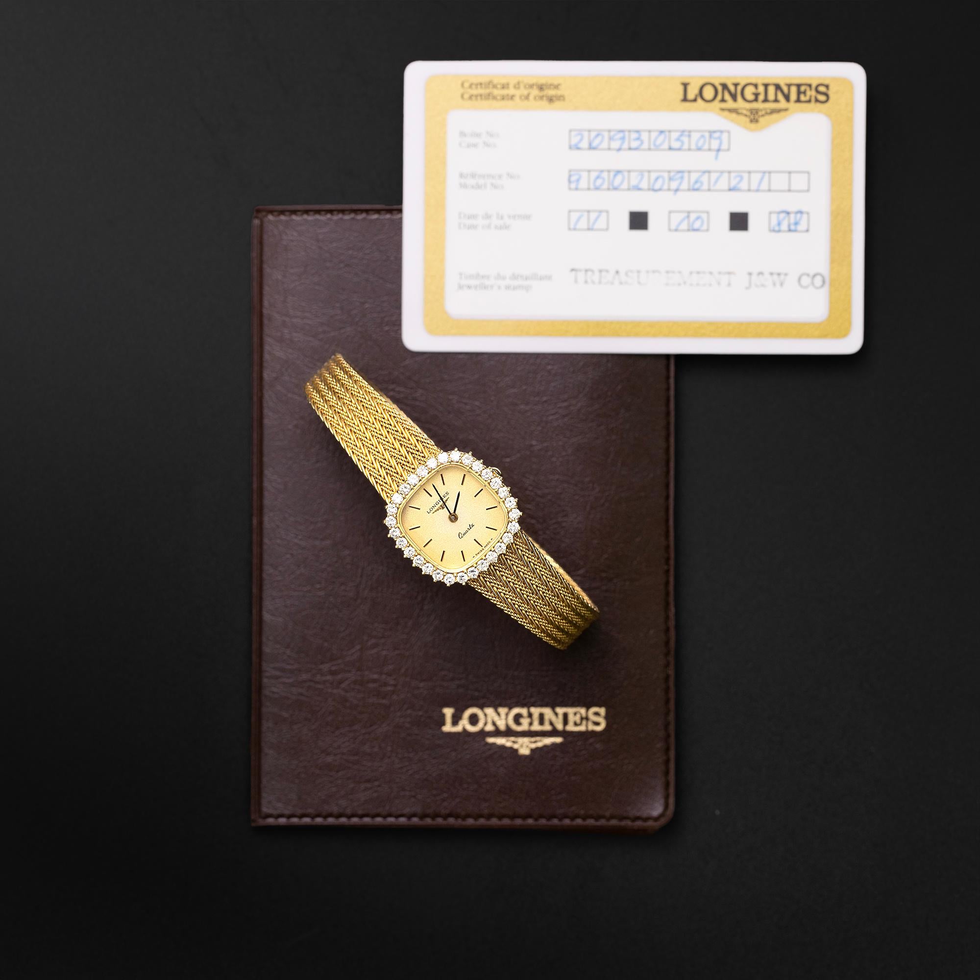 A late 1980s Longines watch is crafted 18k yellow gold with a factory made mesh band with an adjustable clasp stamped Longines. Featuring a frosted gold dial surrounded by brilliant cut diamonds. The case is stamped 20 930 509 and is presented with