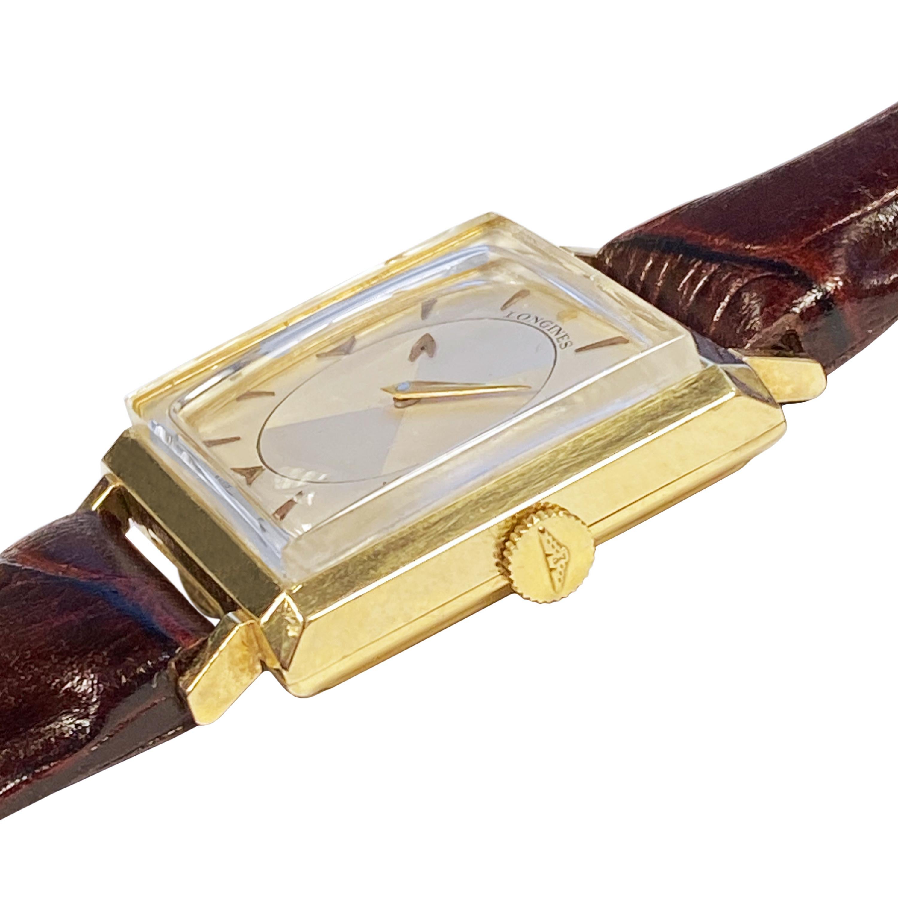 Circa 1950 Longines Mystery Dial Wrist Watch, 36 mm ( lug end to end ) X 37 mm. 14K yellow Gold 2 piece case, 17 jewel, mechanical, manual wind movement, original near mint condition 2 tone silver satin dial with raised Gold markers, center hour