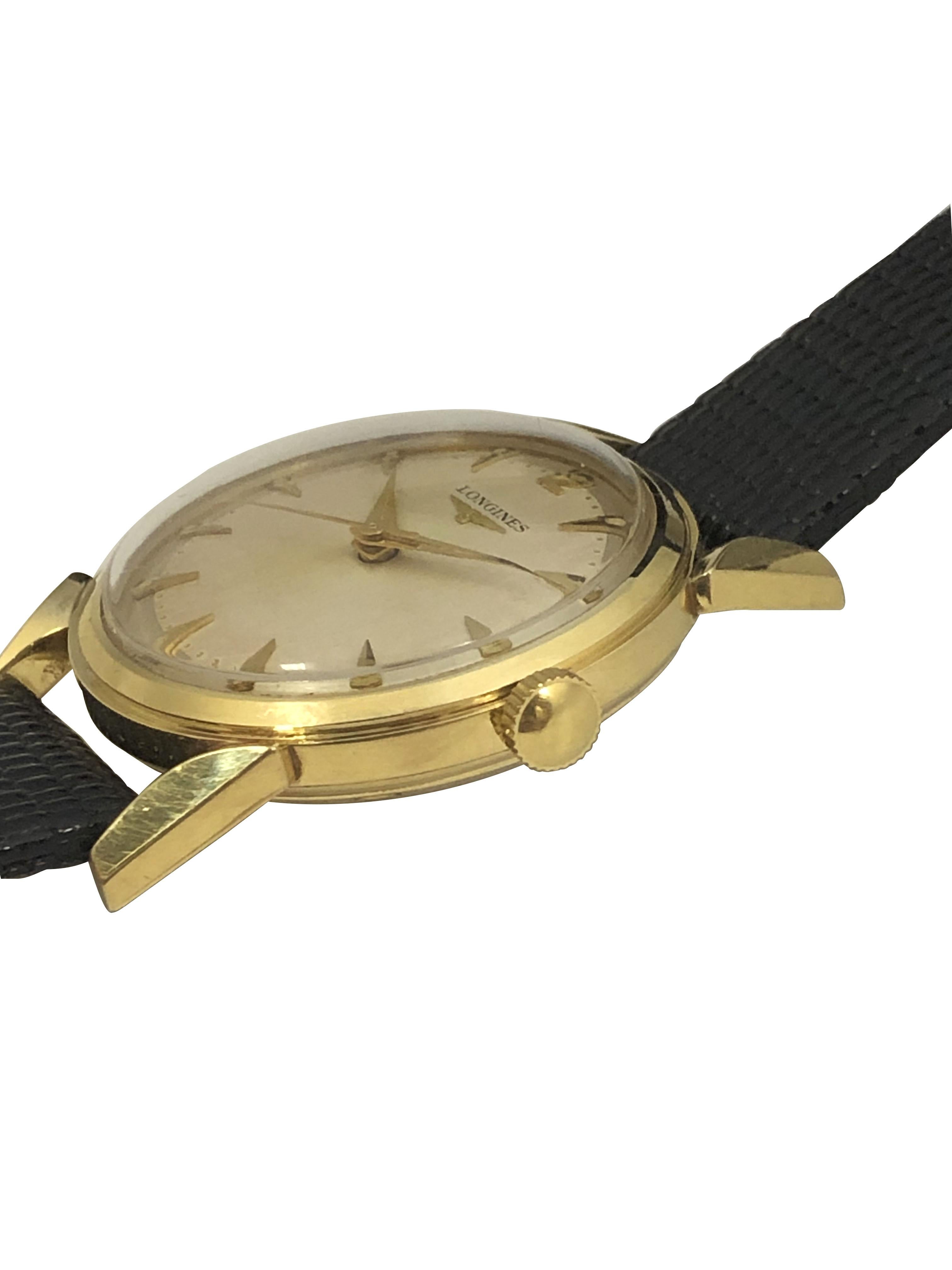 Circa 1950s Longines Wrist Watch, 33 M.M 14k Yellow Gold 3 piece case with water proof back and flared lugs, Caliber 23 ZS 17 jewel mechanical, manual wind movement, beautiful mint crisp condition Silver Satin Pie Pan dial with raised gold applied