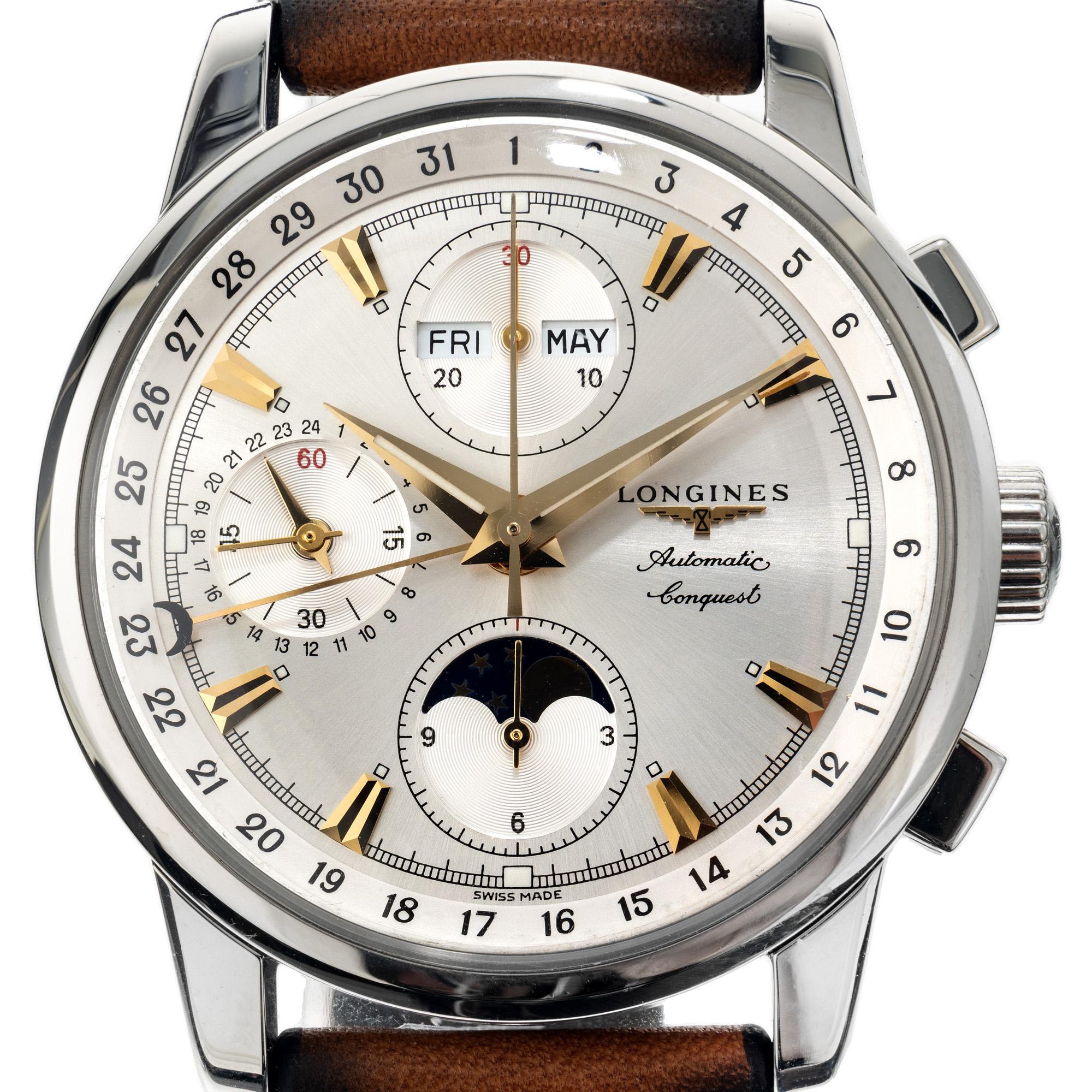 Men's heritage collection Longines automatic chronograph day date month complicated steel watch. Which also includes a Moonphase feature. The dial is silver tone with gold tone markers. The band is new and not original to the watch. 

Length: