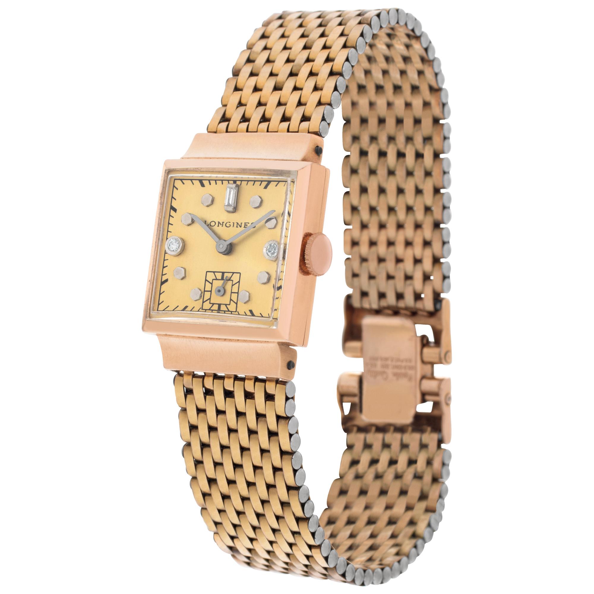 Longines Classic in 14k pink gold on gold plate band. Manual w/ subseconds. Fits 6.50 inches wrist. 22 mm case size. Ref 195611. Circa 1960-1970s. Fine Pre-owned Longines Watch.

Certified preowned Vintage Longines Classic watch is made out of rose