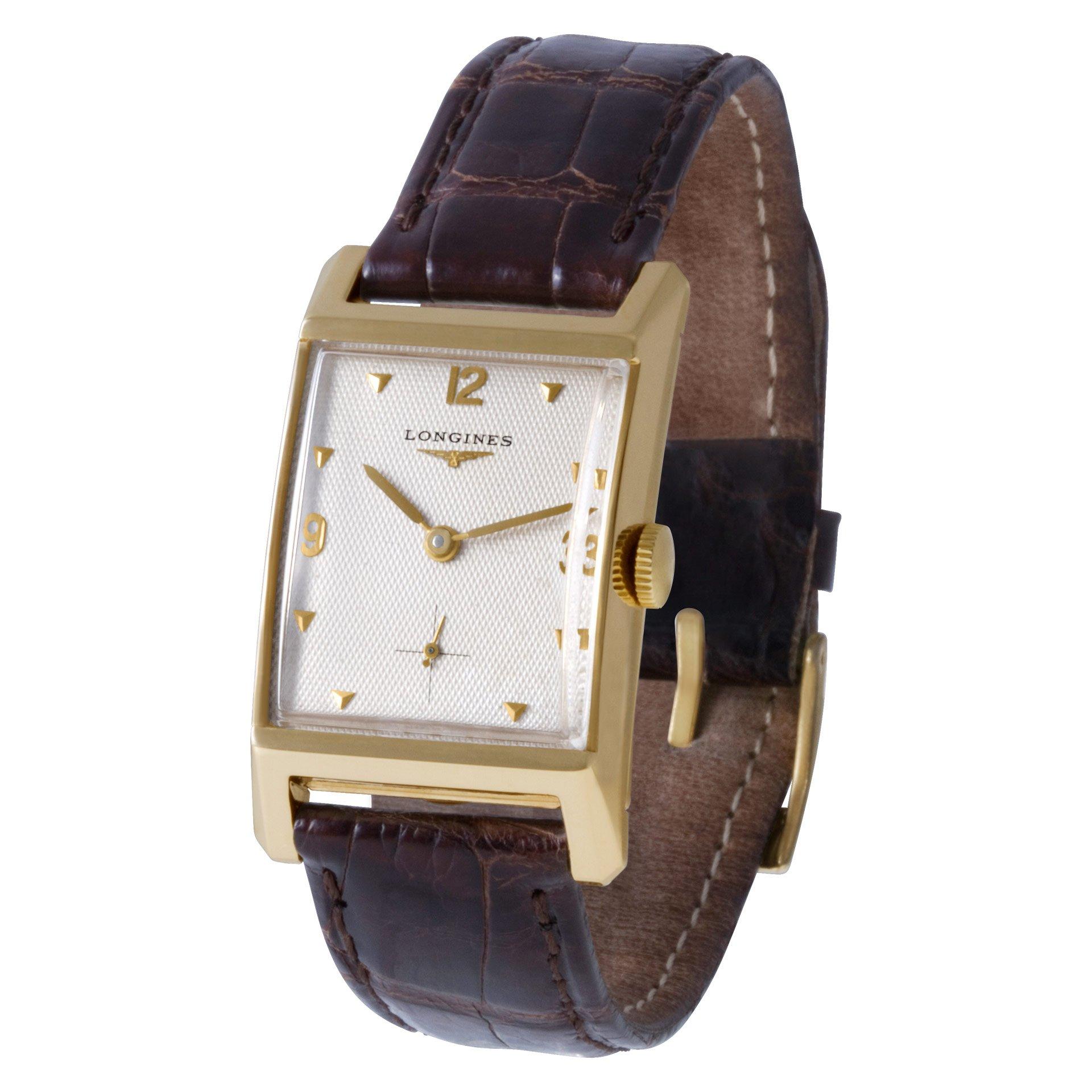 Vintage Longines Classic in 14k on a brown alligator strap with 18k tang buckle. 24 mm Case size. Manual. Fine Pre-owned Longines Watch.

Certified preowned Vintage Longines Classic watch is made out of yellow gold on a Brown Leather Original band