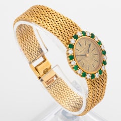 Longines Cocktail Watch, 18K Yellow Gold, 12 x Emeralds / Diamonds. Circa 1964.