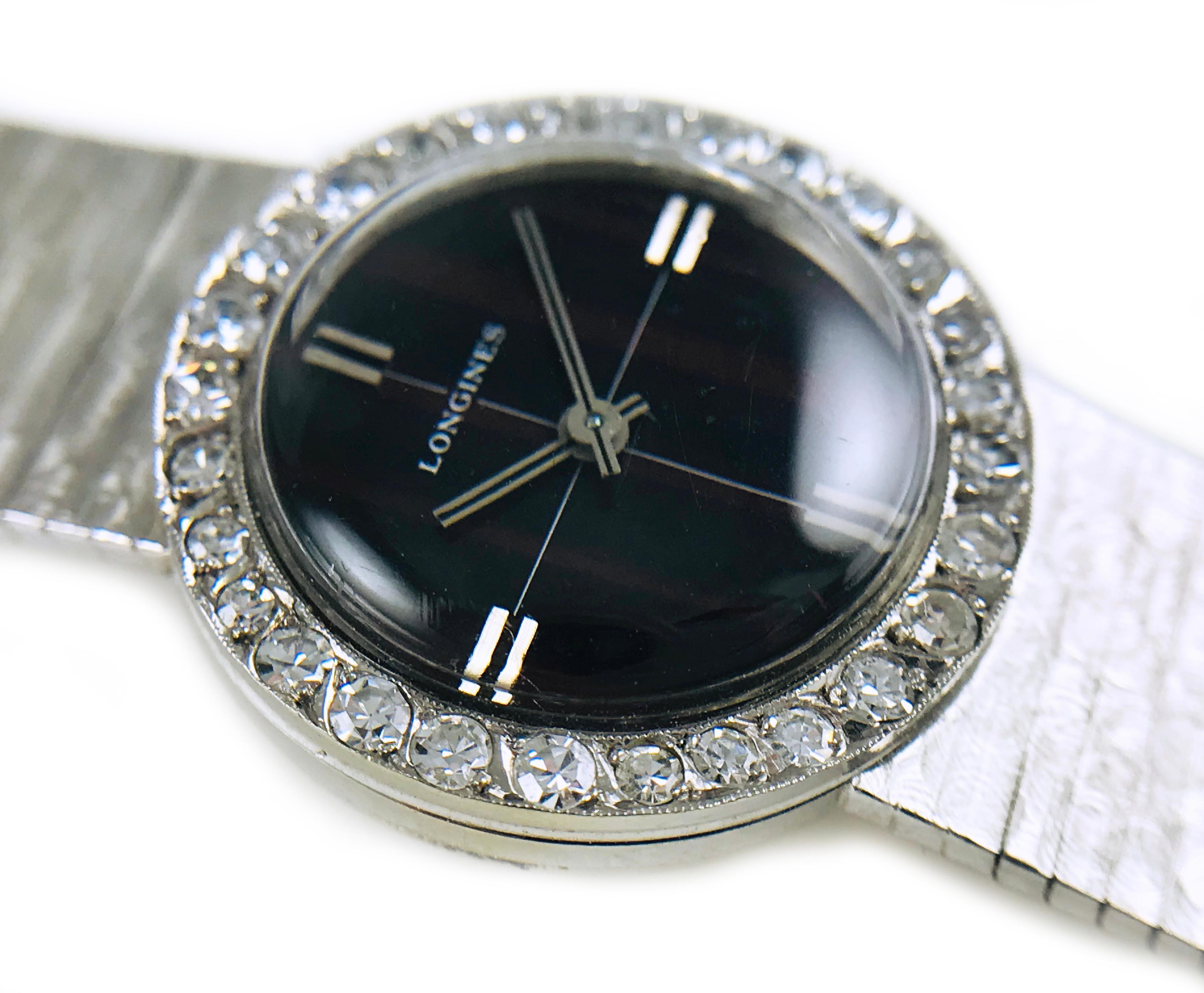 Longines Diamond Gold Watch, 1955. The dial has a unique black and burgundy shadow pinstripe pattern. Twenty-eight round diamonds adorn the dial. The watch has double white gold hours and double white gold bars for the hour and minute hands. 14k