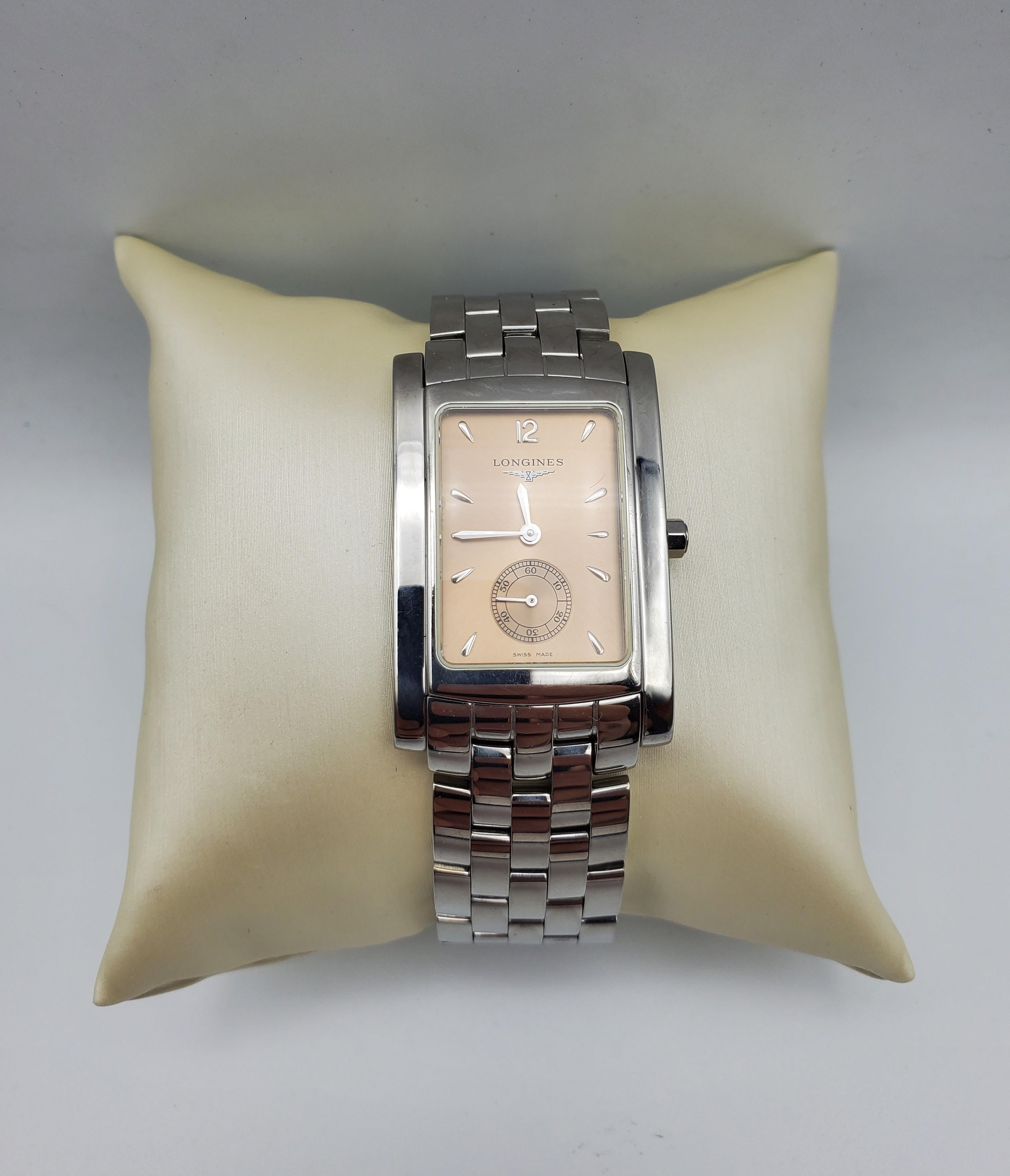 Longines Dolce Vita Tank Watch, Quartz, Champagne/Peach Face, Stainless Steel, Swiss-Made. Like New Condition. Beautiful Champagne/Peach Face. Water resistant 30. The case  is 26mm by 39mm in diameter and 6.6mm thick. The bracelet has a 20mm lug,