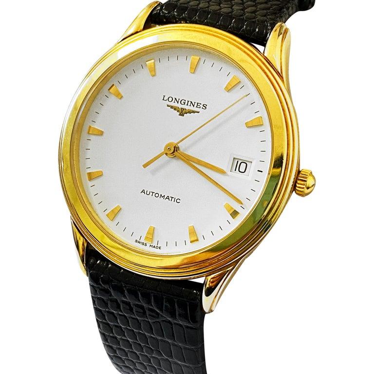 BRAND: Longines
MODEL: Flagship
MATERIAL: 18K Yellow Gold and Crocodile Skin
MOVEMENT: Automatic
CONDITION: Mint Condition
OTHER: Date feature

FACE DETAILS
DIAL: White
MATERIAL: 18K Yellow Gold

BAND DETAILS
MATERIAL: Genuine Crocodile