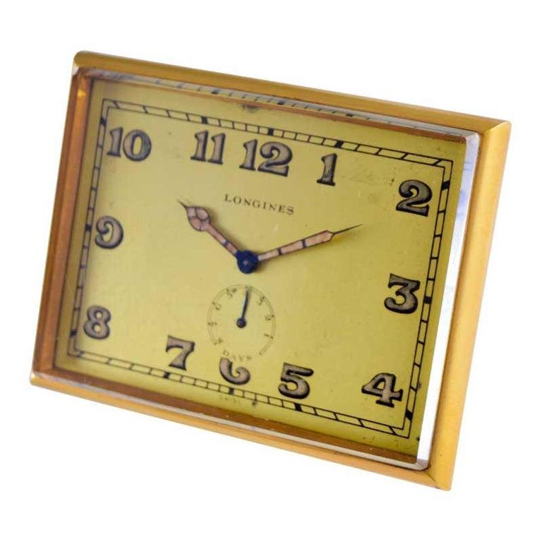 FACTORY / HOUSE: Longines Watch Company
STYLE / REFERENCE: Art Deco Desk Clock 
METAL / MATERIAL: Gilded Brass
CIRCA / YEAR: 1930's
DIMENSIONS / SIZE: 3 1/2 X 2 1/2
MOVEMENT / CALIBER: Manual Winding / 17 Jewels / Power Reserve High Grade
DIAL /