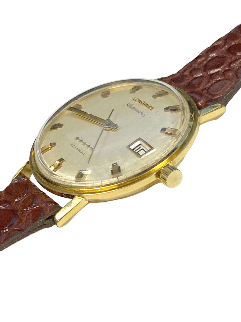 Circa 1972 Longines Admiral 5 Star Gents Wrist Watch,  34 M.M. 14k Yellow Gold 2 piece case with 17 Jewel Automatic, Self winding movement. Original Silver Satin dial with raised Gold markers, Sweep seconds hand and a Calendar window at the 3