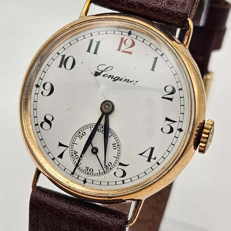 Longines Men's 9ct Gold Wristwatch Fully Serviced 1 Year Guarantee
Longines - A Swiss 9ct gold 'trench' style wristwatch, circa 1920's, the signed circular white dial, 25mm diameter, with black Arabic numerals (12 in red), blued moon hands,