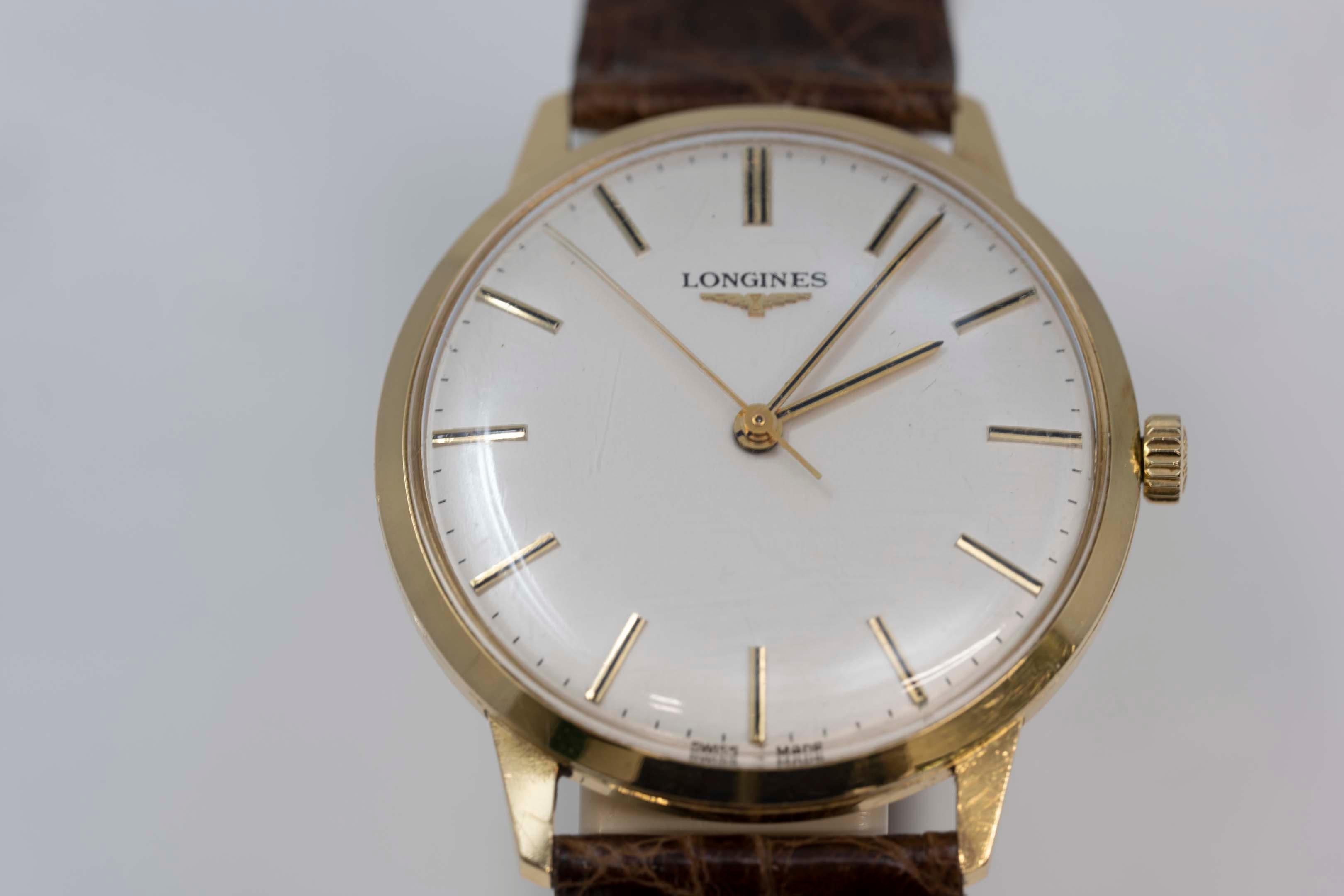 Longines 18k gold men's watch circa 1970, cal706, case 35mm excluding crown. White silver dial, 17 jewels, hand wound movement, new crocodile brown strap, no box. In good working order. Minor wear due to usage and Made in Switzerland.
