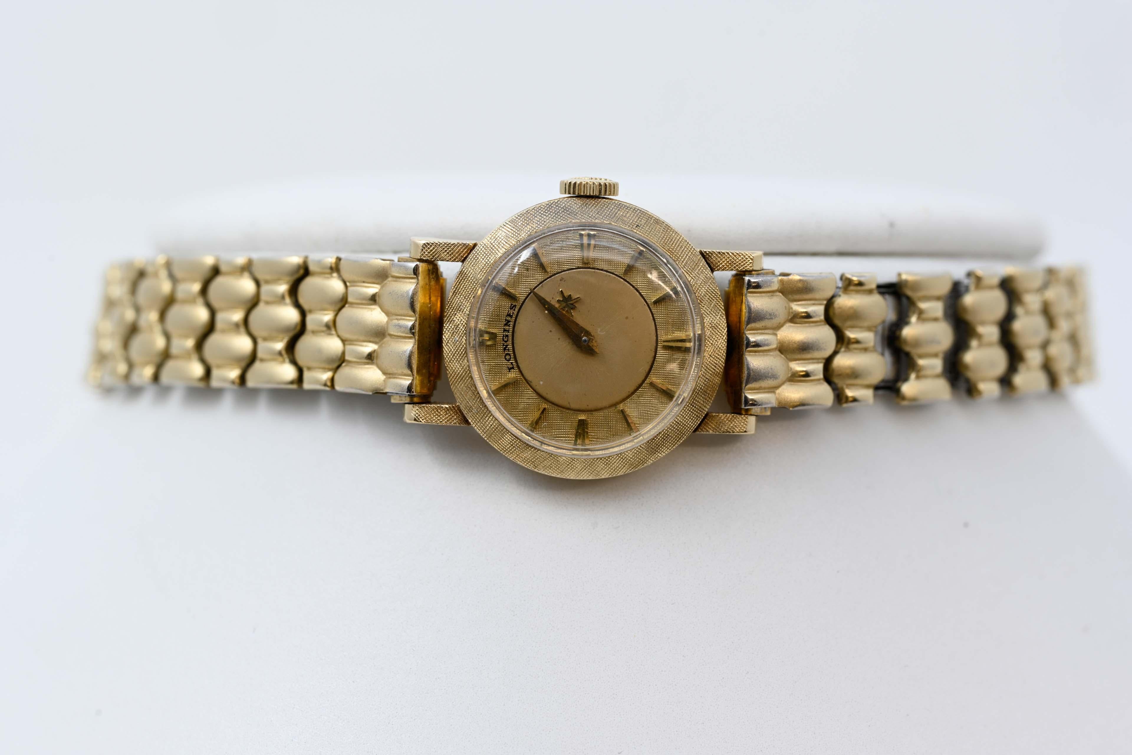 Longines mystery dial ladies watch 14k yellow gold with extension Speidel bracelet. Original gold crown, case 19mm gold dial and 20mm with crown. Mechanical movement ,stamped 14k, Made in Switzerland circa 1960-70, working order.
