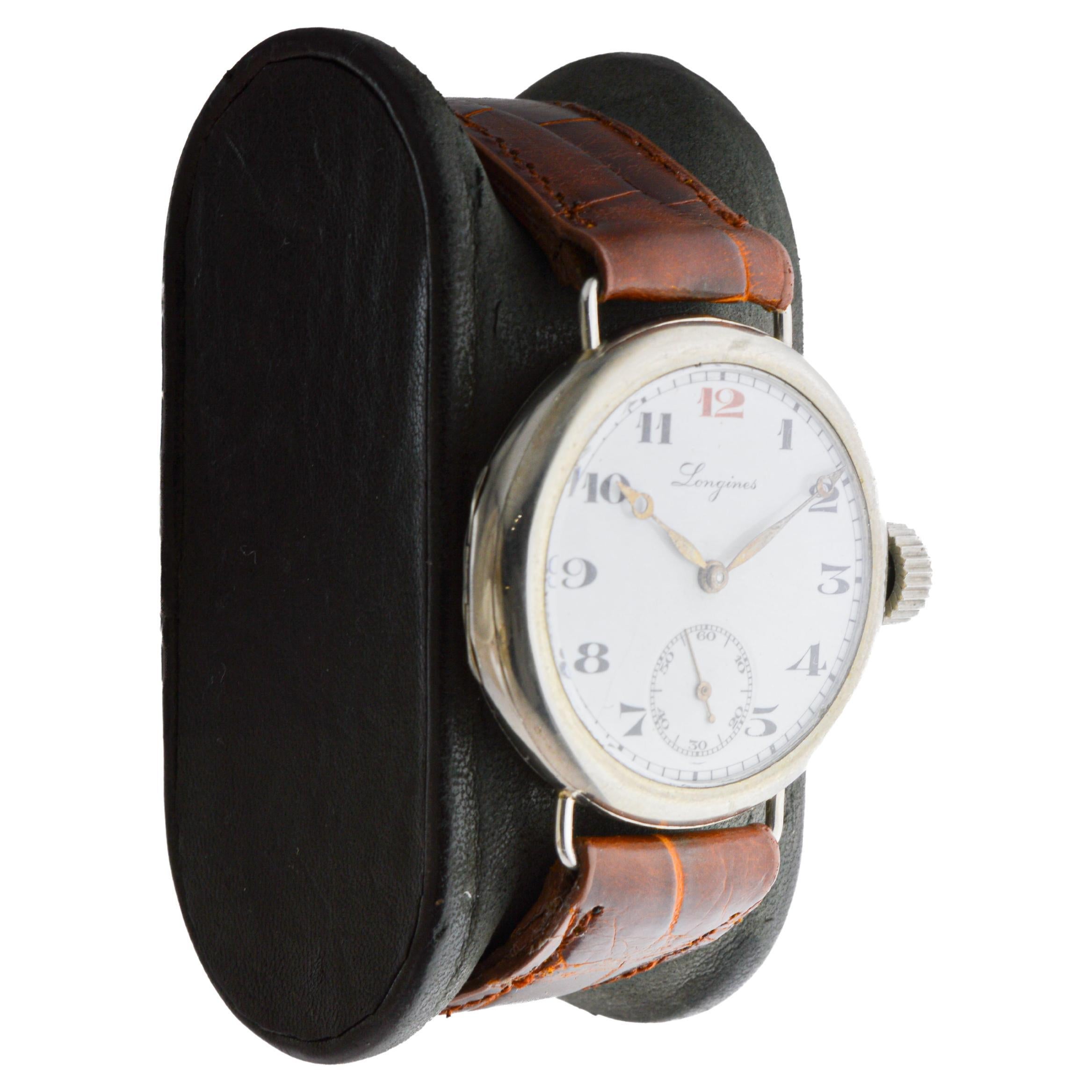 FACTORY / HOUSE: Longines Watch Company
STYLE / REFERENCE: Military / Campaign Style
METAL / MATERIAL: Nickel
CIRCA / YEAR: 1915
DIMENSIONS / SIZE: Length 43mm X Diameter 33mm
MOVEMENT / CALIBER: Manual Winding / 15 Jewels / Caliber 13-34 
DIAL /