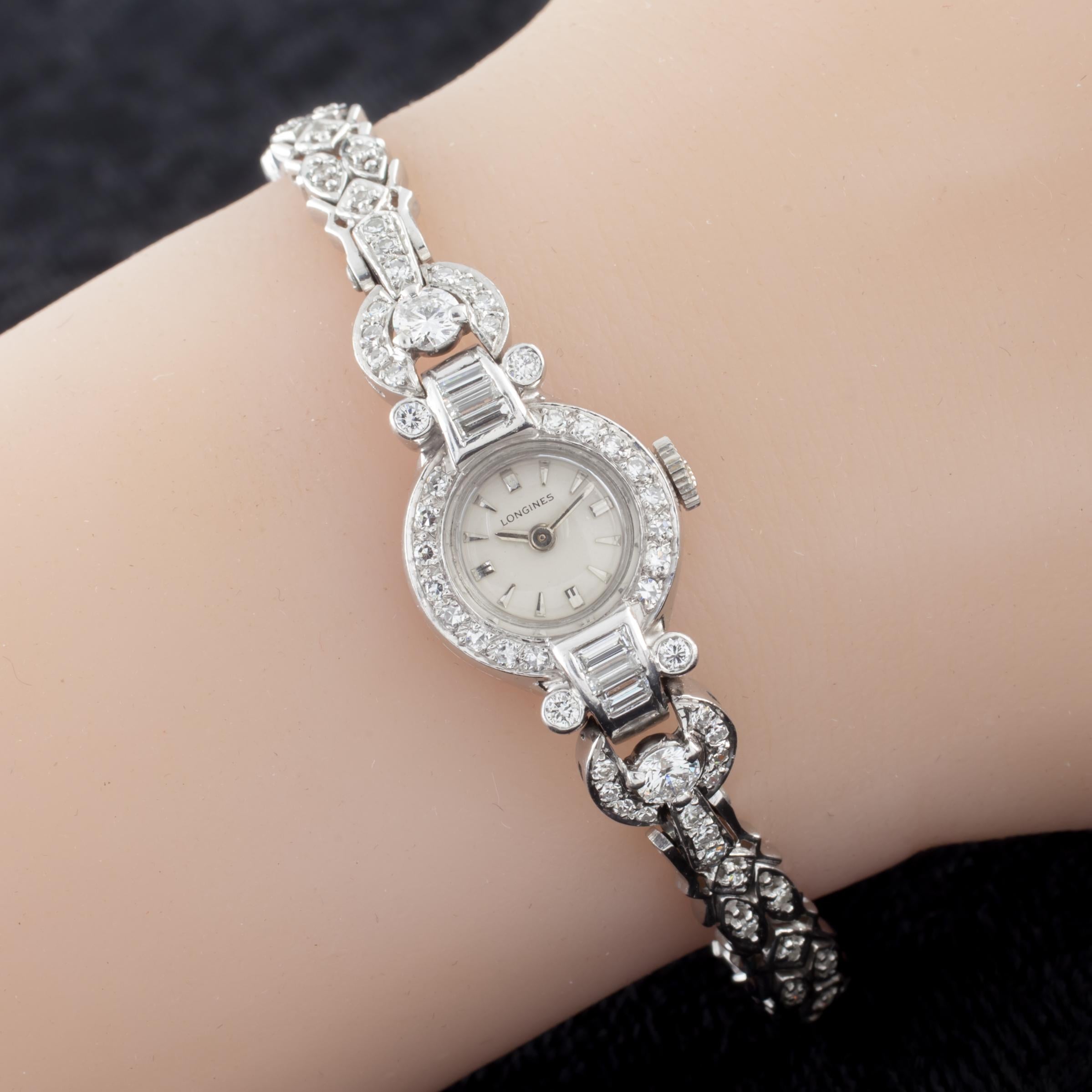Longines Platinum & 14k White Gold Diamond Women's Dress Watch
Movement #4LLV
Serial #11926684
Total Diamond Weight = Approximately 2 carats

Platinum Case w/ Diamond Bezel and Lugs
12.7 grams
16 mm in Diameter (17 mm w/ Crown)
Lug-to-Lug Distance =