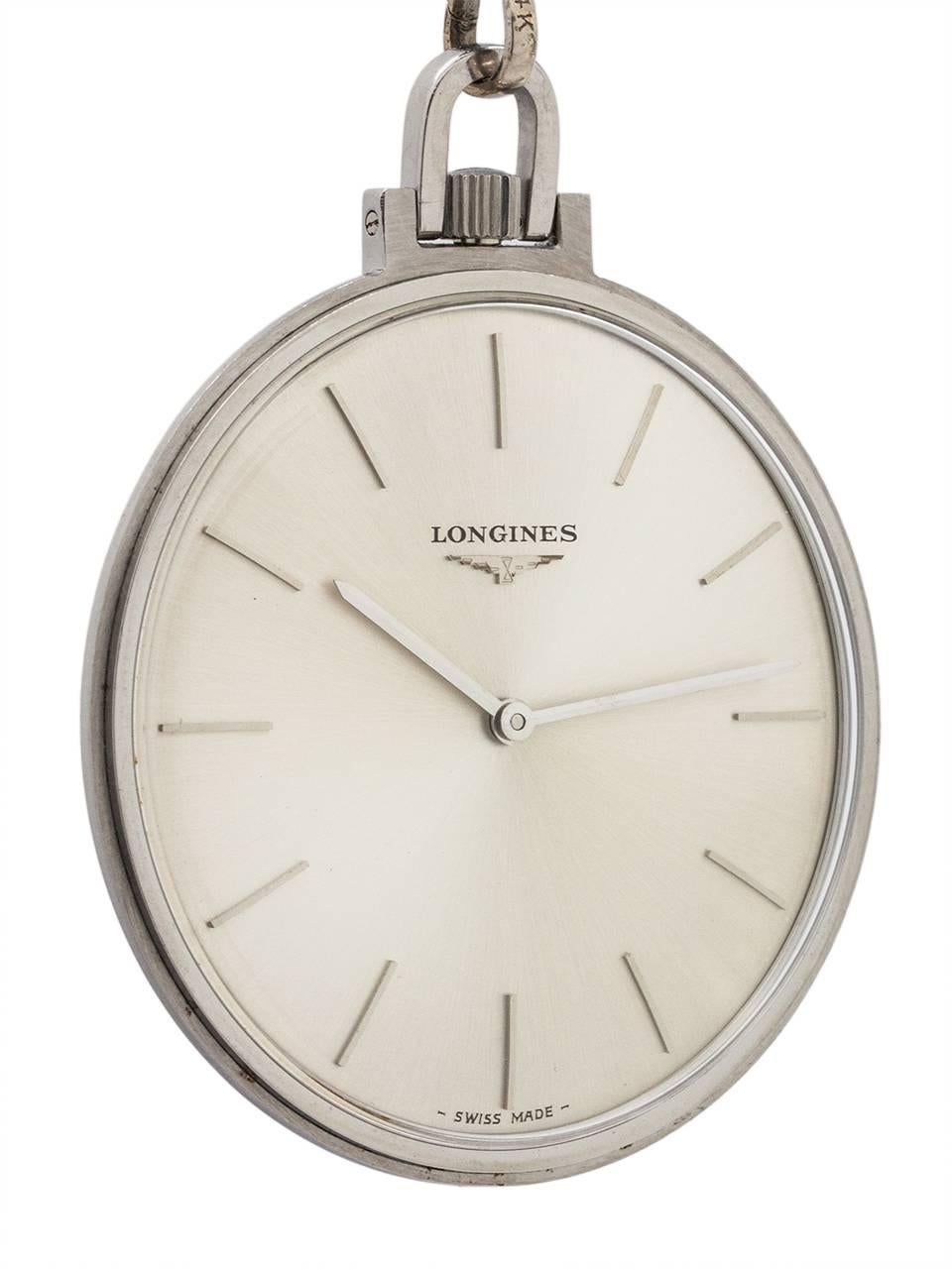 
Vintage Longines man’s pocket watch circa 1960’s. Featuring a 40.5mm diameter open face “modernist” design stainless steel case with stylized U shaped bow, and very minty condition original silvered satin dial with minimalist stick indexes and
