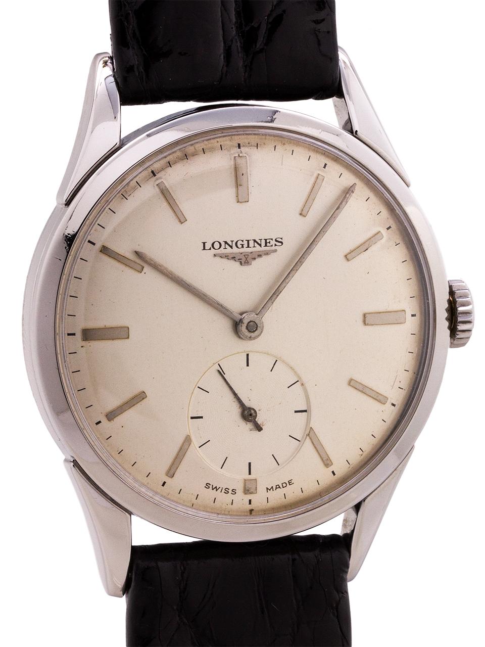 Classic and sophisticated Longines stainless steel manual wind mid century design dress model circa 1956. Featuring a 35mm case with bowed lugs, and with very clean original matte silvered dial with applied baton indexes and elongated silver baton