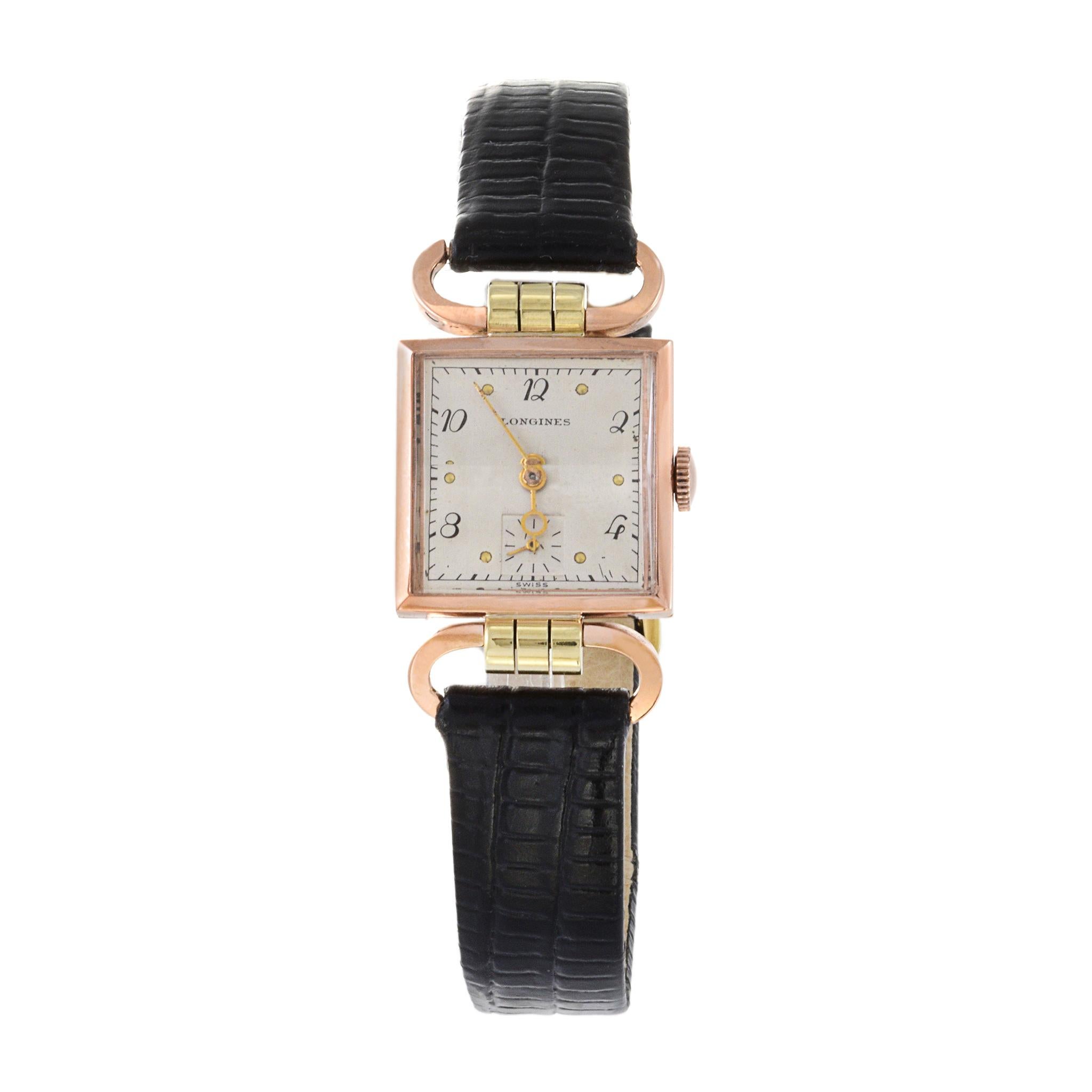 This is an elegant 1950's Longines tank watch in 14K rose and green gold. The most unique features of this watch are the opposable lugs and original beveled crystal. The case measures 21mm in diameter. It is 37mm lug to lug.

This watch is powered