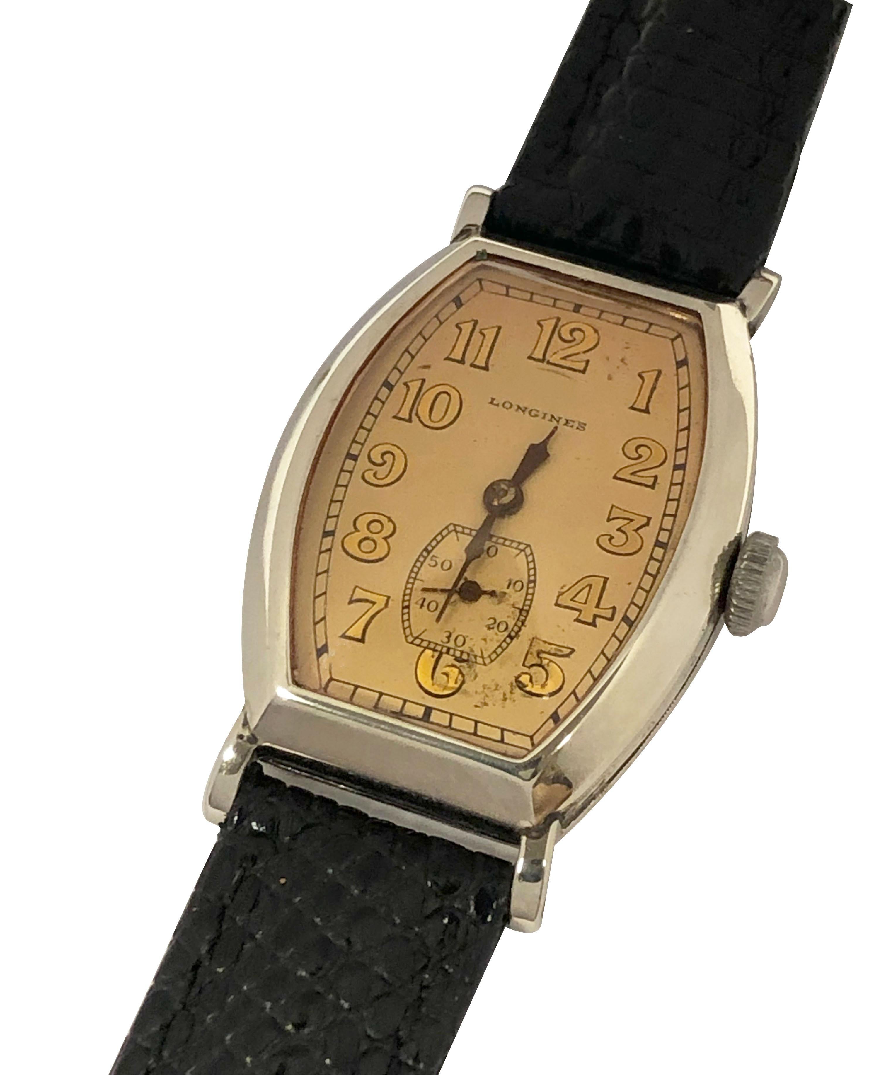 Circa 1930 Longines gents Wrist Watch, 33 x 26 M.M. 14k White Gold filled Tonneau shape case with engraved details and flared lugs. 15 jewel nickle lever mechanical, manual wind movement, original Silver Satin dial with Gold embossed Arabic numerals