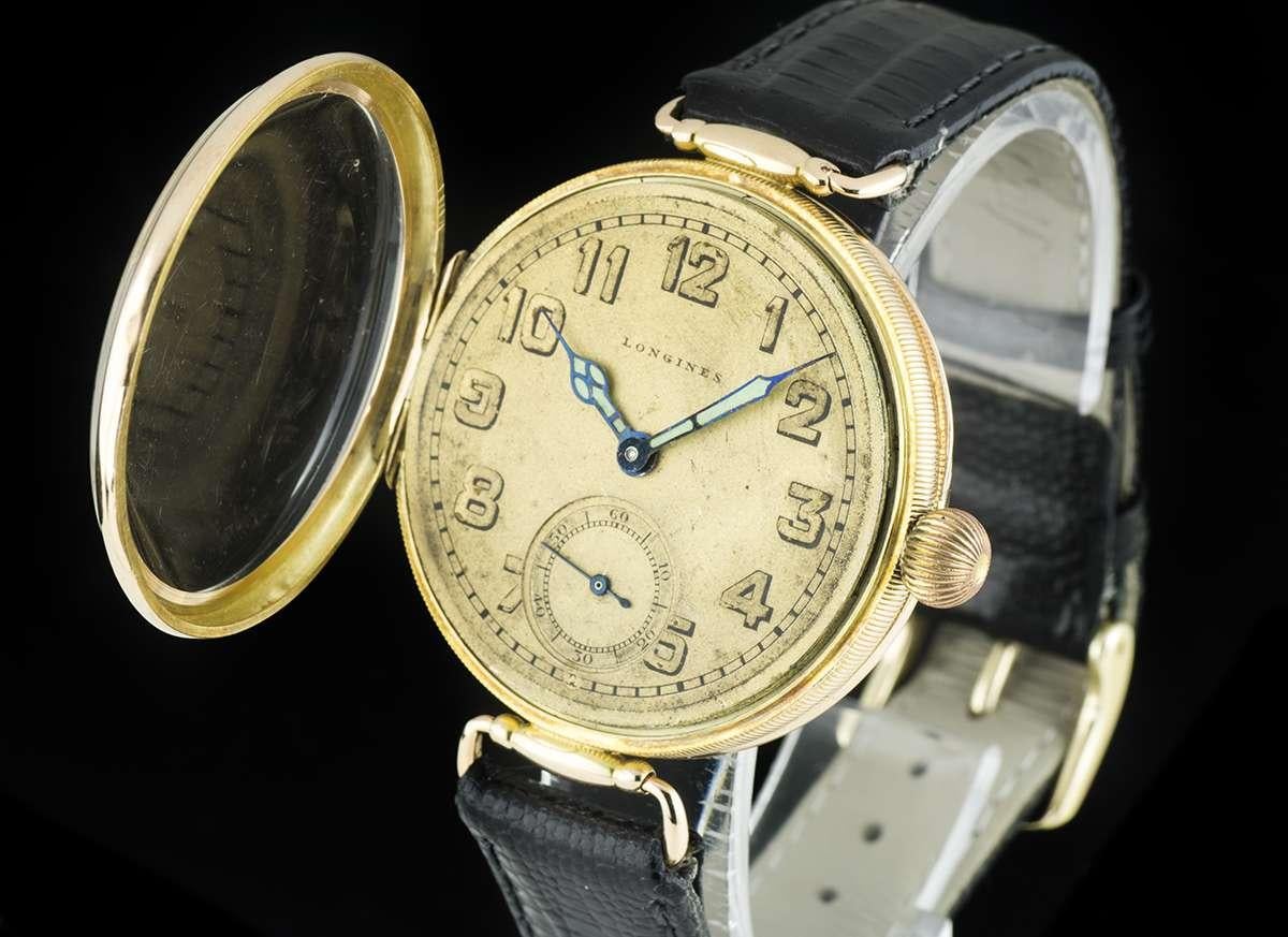 From 1915, designed originally for the Russian market.  This is a 38mm 14K Yellow Gold Open Face Vintage Gents Wristwatch, original champagne dial with arabic numbers, small seconds at 6 0'clock, a fixed 14k yellow gold bezel, a 14k yellow gold