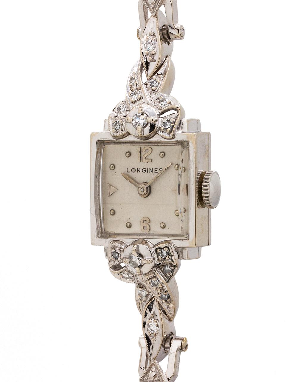 
Lady Longines 14K white gold & diamond set cocktail watch circa 1940’s. Very nice looking vintage diamond set watch with associated 14K white gold diamond set bracelet. Featuring silvered satin dial, dome crystal, and rectangular case surrounded by