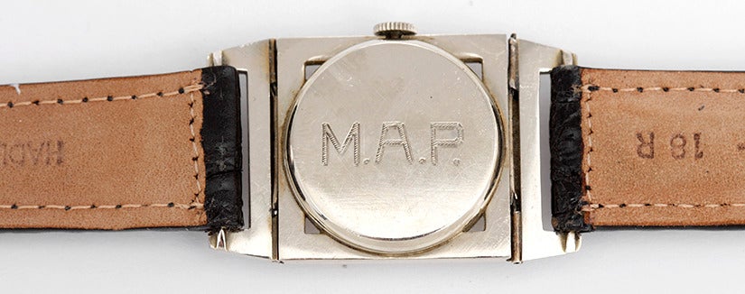 Manual winding. 14k white gold case with hinged lugs. The back is engrave M.A.P.  (25mm x 40mm). Ivory colored dial with black Arabic numerals. Black strap band. Pre-owned with custom box. Rare and unusual Art Deco Longines with ca. 1920's/30's.