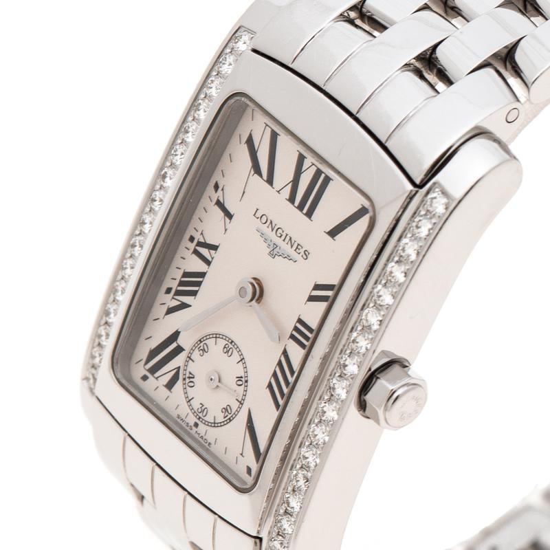 With a resilient white stainless steel casing and strap, this Dolcevita wristwatch from Longines is made to last for years. It has bands of diamond studs running vertically down on either side of its dial. Its rectangular face features a simple