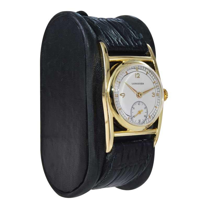 FACTORY / HOUSE: Longines Watch Company 
STYLE / REFERENCE: Art Deco 
METAL / MATERIAL: Yellow Gold Filled 
CIRCA / YEAR: 1950's
DIMENSIONS / SIZE: Length 39mm x Width 26mm
MOVEMENT / CALIBER: Manual Winding / 17 Jewels / Caliber 10L
DIAL / HANDS: