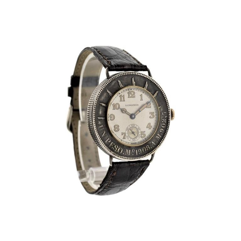 FACTORY / HOUSE:   Longines Watch Company
STYLE / REFERENCE: Un Peso Silver Coin 
METAL / MATERIAL: Silver with Gold Bezel
DIMENSIONS:  44mm X 40mm
CIRCA: 1928 / 1929
MOVEMENT / CALIBER: Manual Winding /  15 Jewels 
DIAL / HANDS: Original Silvered