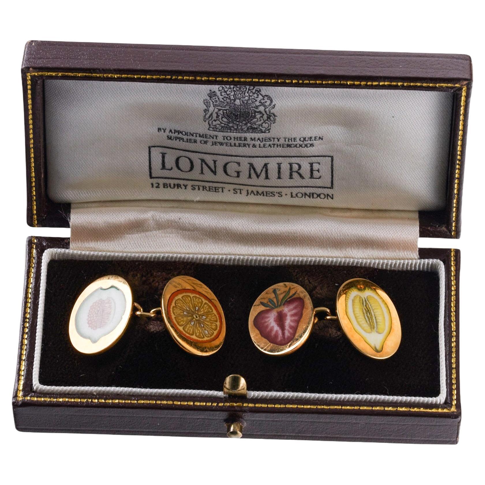 Pair of 18k gold oval cufflinks, crafted by Longmire of London, adorned with enamel fruits - lemon, melon, strawberry and orange, cut in half. Each top is 19mm x 15mm. Come in original fitted box. Hallmarked Longmire, PL, English gold marks. Weight