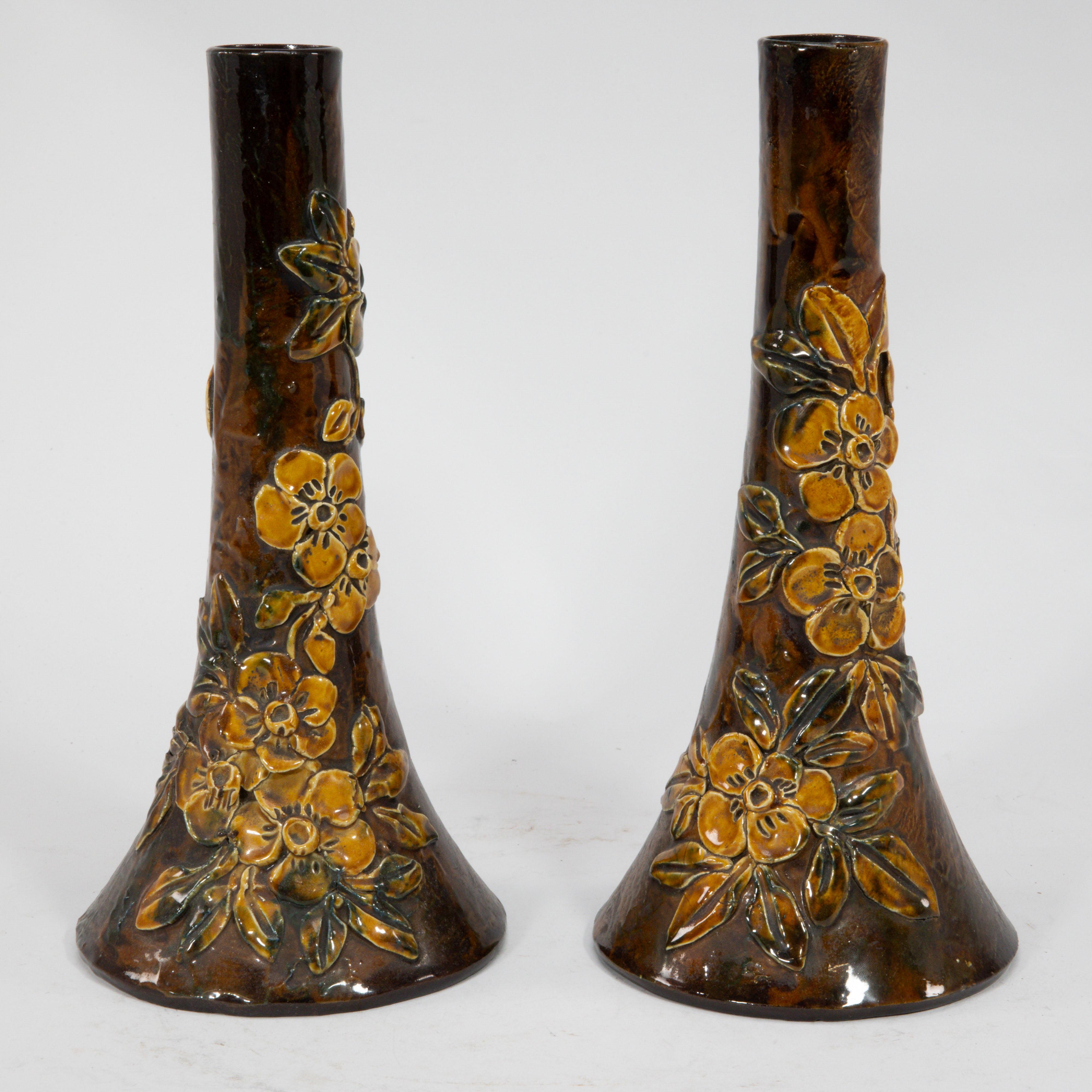 Longpark Pottery Torquay Devon. A pair of rustic ceramic vases with applied floral decoration and a typical yellow glaze to the flowers and brown glaze to the body. One incised with Longpark Torquay. Price for the pair.