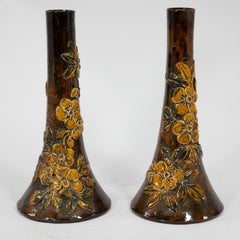 Longpark Pottery. A pair of rustic ceramic vases with applied floral decoration