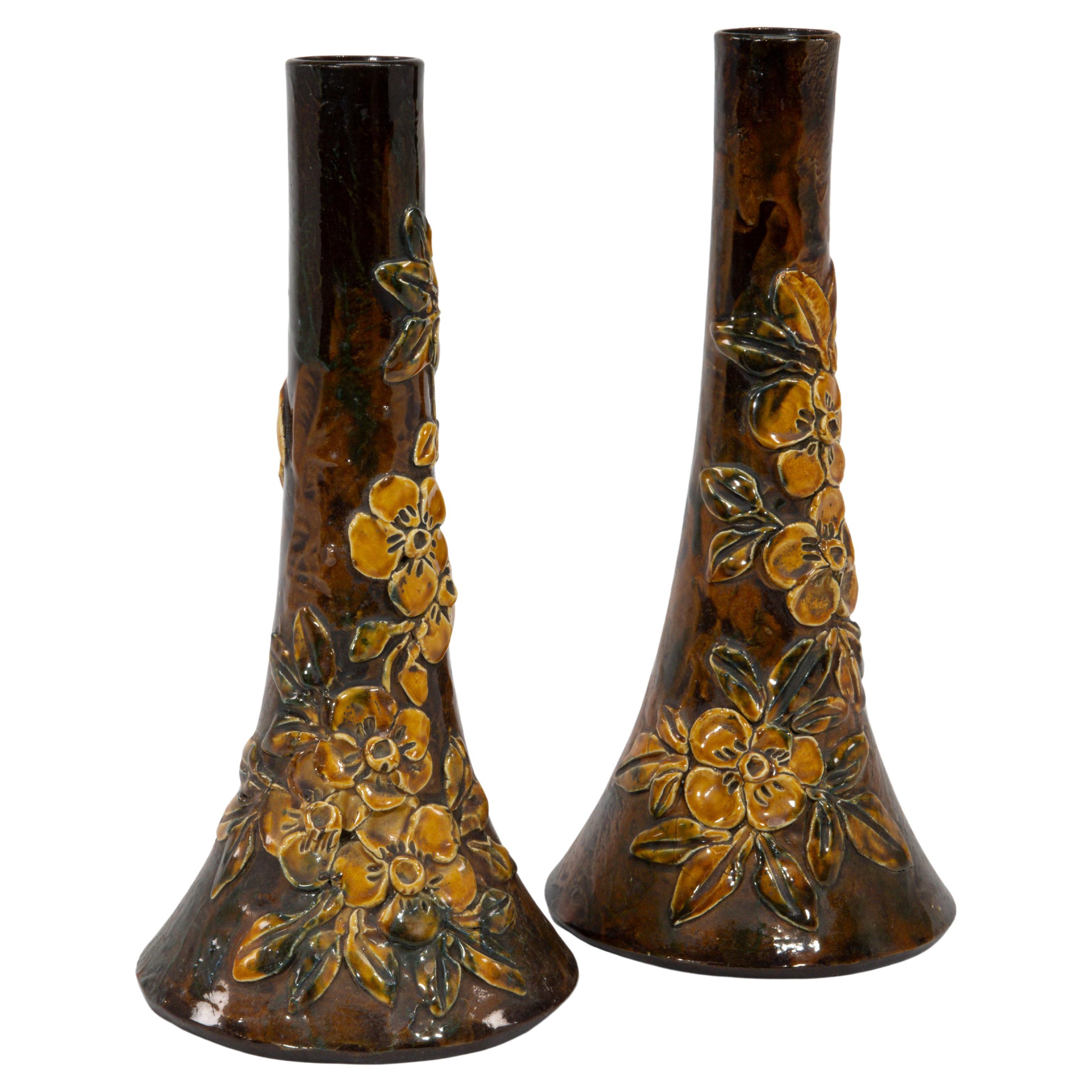 Longpark Pottery. A pair of rustic ceramic vases with applied floral decoration