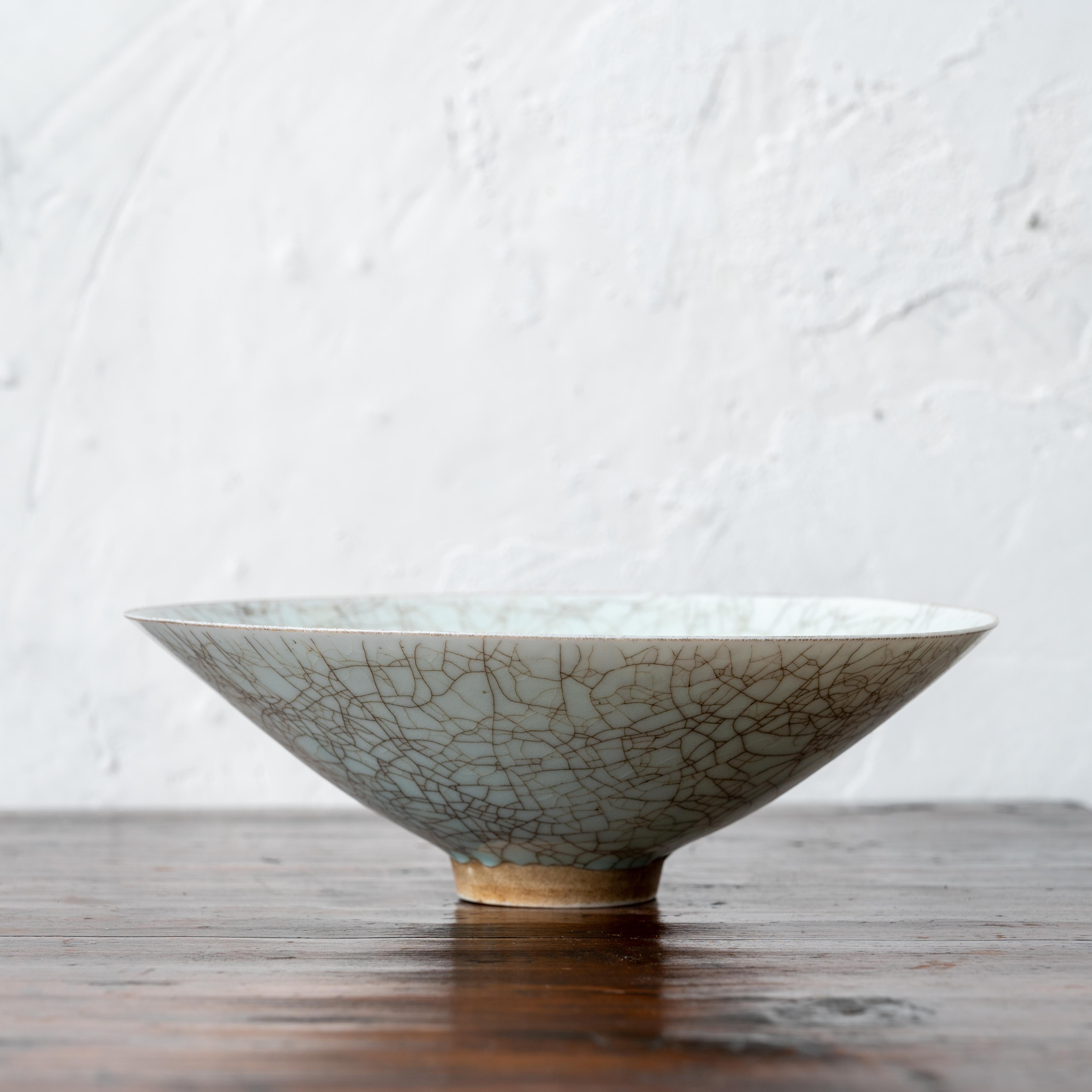 A Longquan style celadon conical bowl with crackled glaze.

7 inches wide by 2 ¼ inches tall

