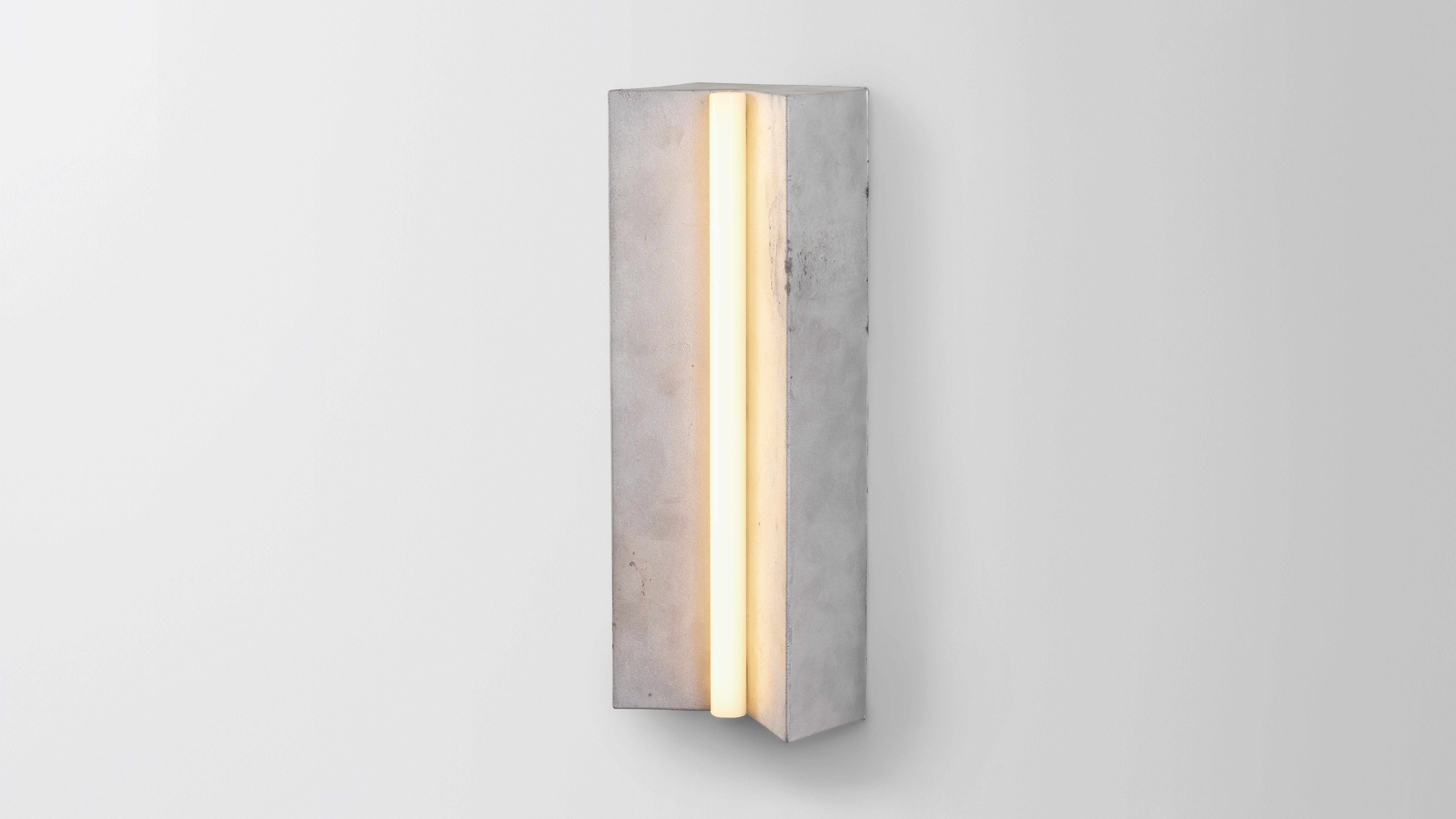 Longton in aluminium by Volker Haug 
Anton series
Dimensions: W 18 H 51 D 10.3 cm
Materials: Cast Aluminium
Finish: Raw (Aluminium) 
Lamp: S14s LED, Opal (240V / 120V US)
Weight: 4kg 

Longton is cast as raw aluminium or polished gunmetal.
Form